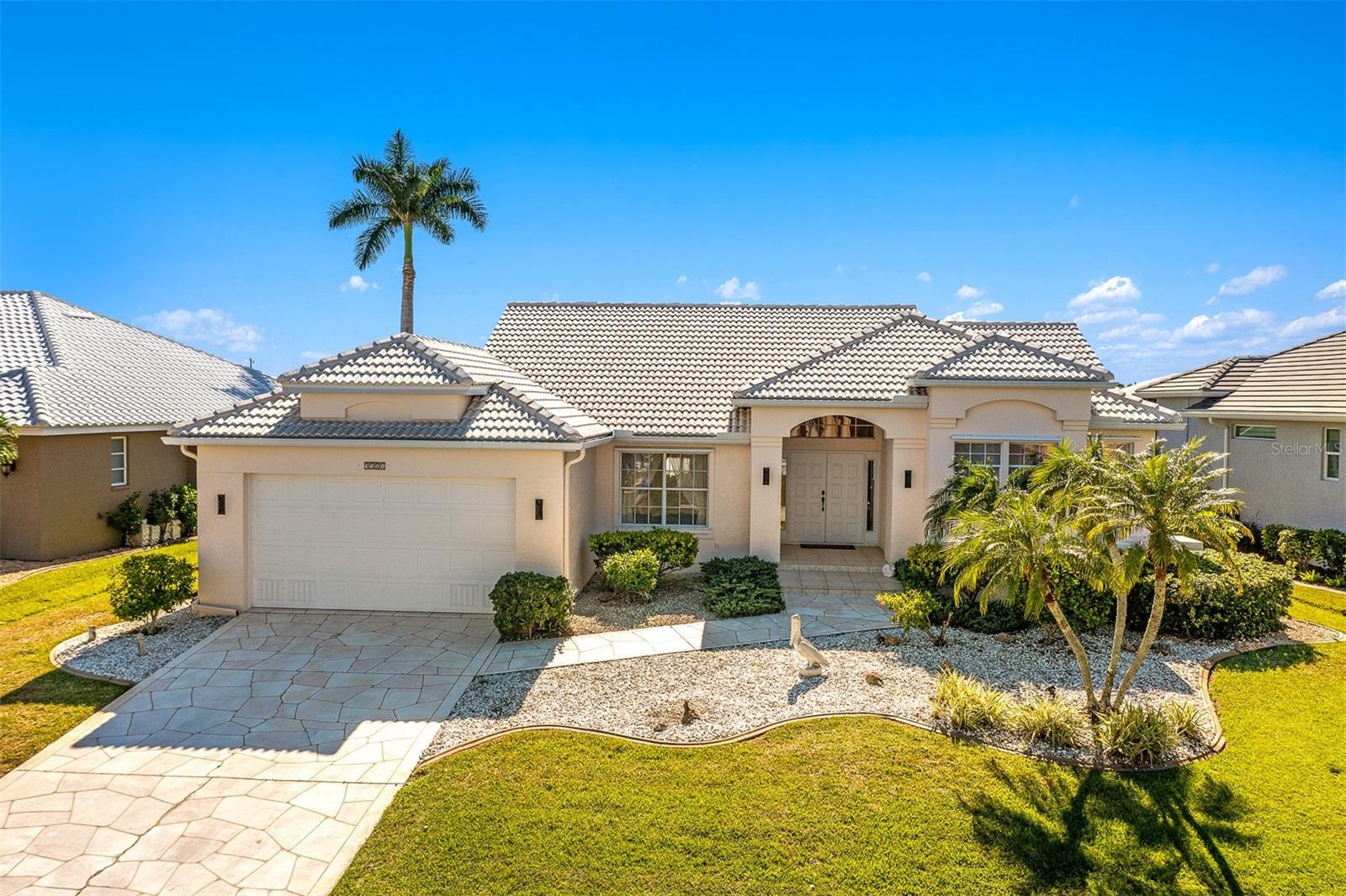 Punta Gorda Isles! Beautiful 3 bed, 2 bath, 2-car garage waterfront pool home with amazing intersecting canal views of wide sailboat basin 
providing access to Charlotte Harbor leading to the Gulf of Mexico. 75’ of water frontage offers concrete dock and seawall with water and electric plus 6,000 lb. lift. This property offers a lifestyle that is truly second to none. As you enter, you'll be captivated by the open floor plan, high ceilings and triple pocket slider in the living area which provides breathtaking water views from the moment you step inside. Interior features built-in accents, neutral decor, and an abundance of natural light that fills every room. Spacious kitchen offers breakfast bar and a casual dining area overlooking the pool, making it the perfect space for entertaining guests. Generous master suite offers long water views and a private ensuite bath with dual sinks, jetted tub and walk-in shower. Step outside to the covered lanai and screened heated 14' x 28' pool, where you can relax and enjoy the serene waterfront views and true southwestern exposure for gorgeous sunsets. Automatic roll down shutters provide added convenience plus manual shutters for complete storm protection. The stamped driveway and mature landscaping add to the curb appeal of this beautiful home. Located in a popular boating and golf community, this home offers easy access to Yacht Club, Fishermen's Village, and the historic downtown area of Punta Gorda. You'll also have the opportunity to indulge in world-class fishing, boating, and fine dining. And if you're in the mood for a beach day, you're just a short drive away. Don't miss out on this incredible opportunity to own a home in this highly sought-after location. Schedule your private showing today!