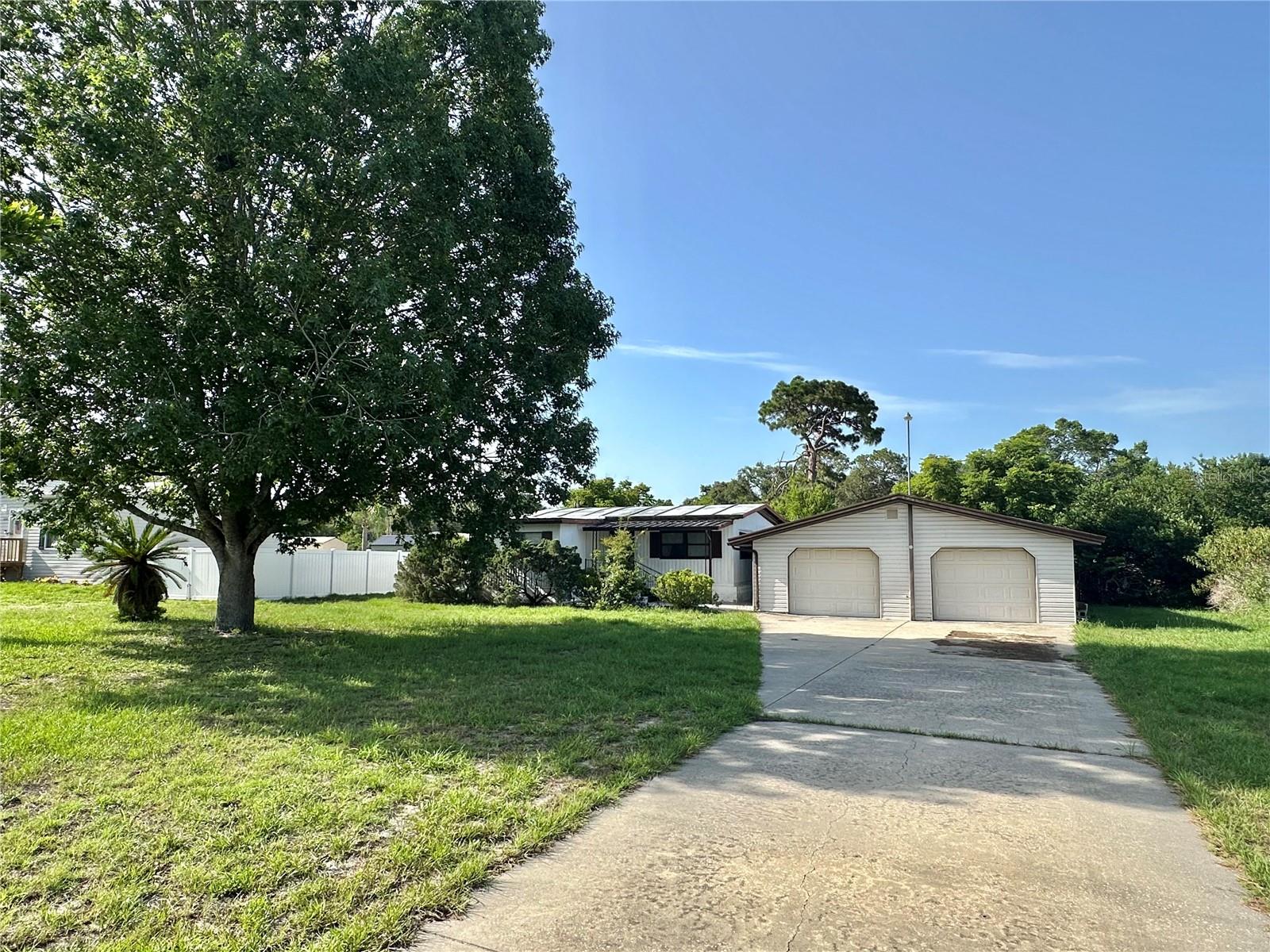 DETACHED 30X30 CONCRETE 2 BAY GARAGE is included with this affordable mobile home on a one half acre lot. No Flooding here yet only 10 minutes from State Parks and boat ramps along the Gulf of America coastline. No HOA and plenty of room for all your toys and projects. Garage with workshop area features  washer and dryer hook up, 30 amp power connector and separate hot water heater. Recent upgrades was a new 200 Amp electrical service in 2019, and the A/C and septic systems in 2020. Has additional electrical and septic hookup for R/V's. Has an additional 16 x 10 storage building. Fivay High School which doubles as the local storm shelter is very close by. This 2bed/ 2bath double wide with 221 sq ft room added to the rear and master bath added to the front provides affordable living in a country setting yet close to town.  Large room in the rear last used as the 3rd bedroom could easily be a family room or area for elderly parent or grand parent. It has outside entry door currently with a wheel chair ramp.. If you want larger then usual lot, a home , and detached garage as a reasonable price, come take a look , today.