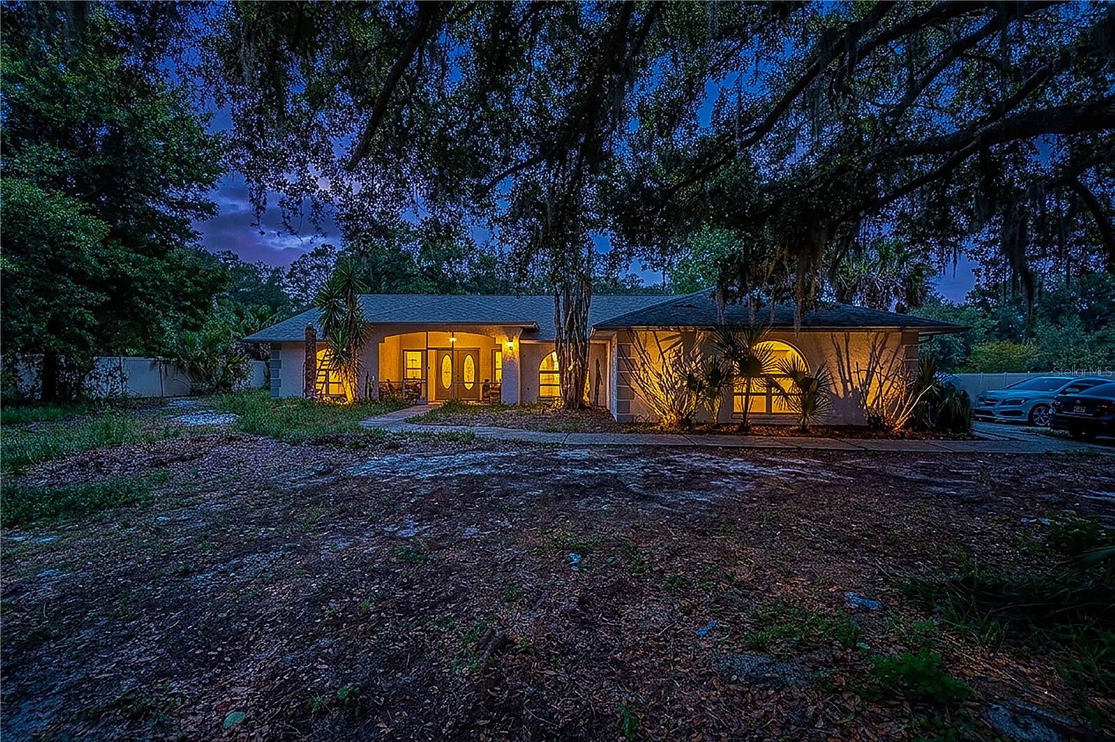 POOL HOME ON 1.41 ACRES IN SOUTH LAKELAND! Rare opportunity to own a spacious 4-bedroom, 2-bath, block home offering almost 2,400 Sq Ft of living space on a beautiful oversized lot surrounded by mature oak trees. This Home features a screened-in swimming pool, Florida room, covered front porch, 2-car garage, vaulted ceilings, and a split-bedroom floor plan.
The spacious primary suite includes pool access and a large ensuite bathroom with dual vanities, a garden tub, and separate shower. The open kitchen overlooks the main living area and offers bar seating, making it ideal for entertaining family and friends.
Outside, you'll find plenty of room for RVs, boats, trailers, gardening, pets, or future improvements. Enjoy the privacy of country living without sacrificing convenience, as you're just minutes from shopping, dining, schools, medical facilities, and the Polk Parkway.
Priced to reflect the opportunity for cosmetic updates, allowing the next owner to customize the home to their taste,
Bring your vision and make this PRIME, PRIVATE & SPACIOUS, South Lakeland property your own!