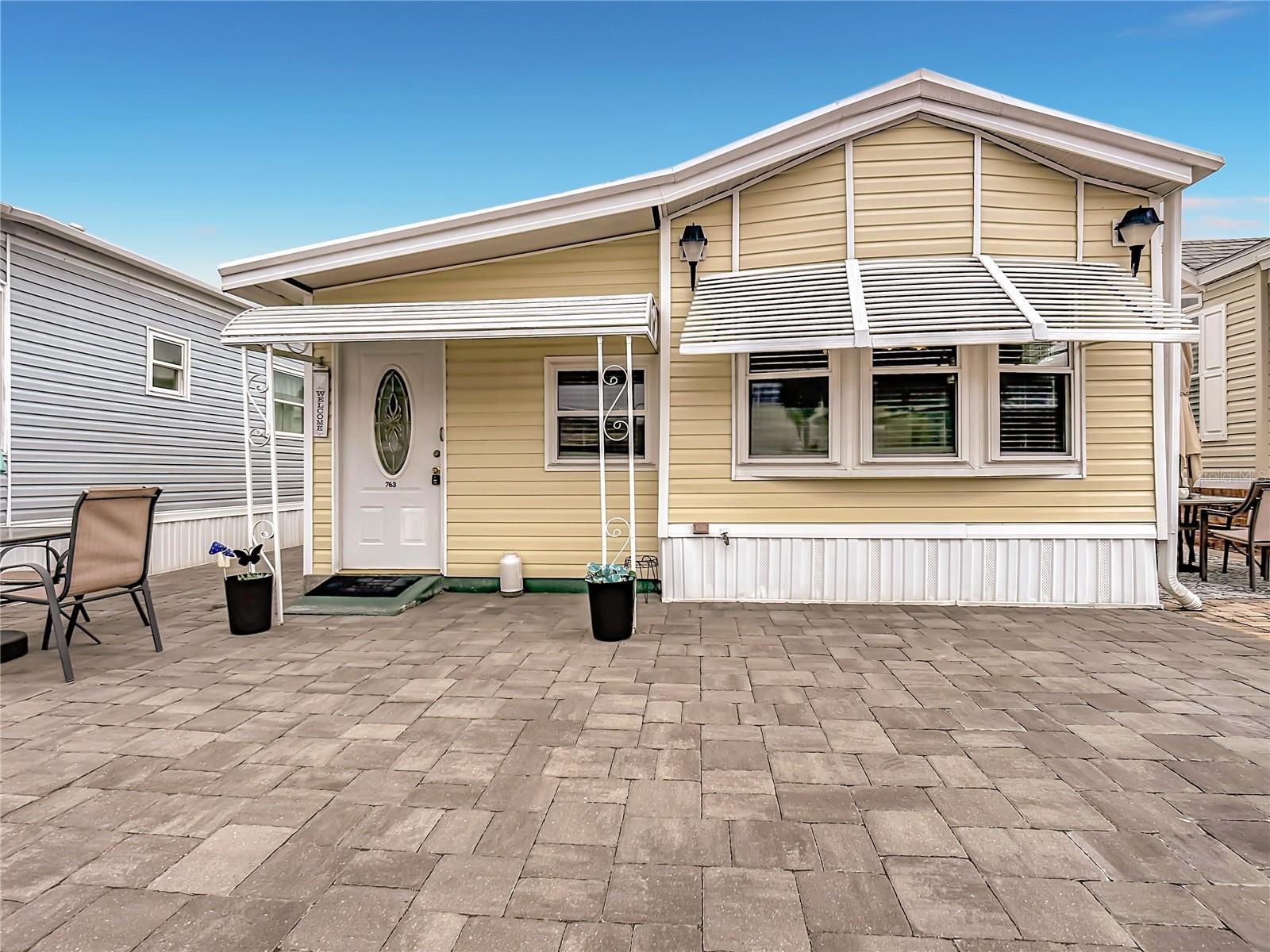 Fantastic location directly across the street from the 2nd community pool and Bath House 3 - great for guests!! This fully furnished 1 bed, 1 bath home offers a large Bonus room (currently used as a 2nd bedroom), totally REMODELED bathroom with large walk-in shower and the home benefits from NEW PLUMBING, NEW VINYL SIDING and EXTRA LARGE paved drive which easily accommodates 2 vehicles. Convenient storage & laundry room lies at the rear of the property and is equipped with new Washer/Dryer.  This highly sought after 55+ guard gated community of Outdoor Resorts has NO LOT RENT - YOU OWN THE LAND!! Come and experience the fantastic lifestyle that this unique community offers. Amenities include 2 heated swimming pools; private access to a 179 acre lake (Lake Davenport); 9 hole golf course; tennis; pickleball; shuffle board; 9 hole putt-putt golf; 8 bath houses scattered throughout the community; laundry facilities; beautiful 2 story clubhouse offering an endless array of entertainment throughout the year. All of this for the low Association Fee of $768 per quarter which also includes Cable TV, Lawn Mowing, Sewer, Trash and Water. UNBELIEVABLE VALUE FOR MONEY - you won't find a more AFFORDABLE LIFESTYLE !!!!  Please remember 55+ and 1 pet rule. The park benefits from close proximity to Disney, medical facilities, restaurants & grocery stores. Don't delay!! Put this home on your 'must see list' and ask to arrange a viewing today.