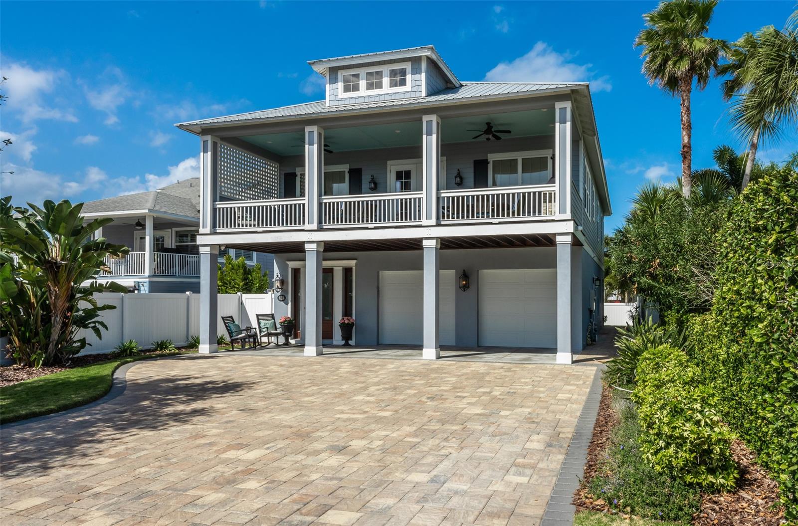Immaculate 2016 4 bedroom, 4 bath Hickson-built home with in-law quarters in the SHORT TERM rental zone.   Great location approximately 600’ to the beach.  Custom throughout! Two stories with elevator.  Beautiful engineered wood floors. Quartzite, granite and marble counters.   Master suite with soaking tub and trough sink.  Repurposed vintage doors, custom window treatments.  Summer kitchen on spacious deck.  Natural gas for stoves, both tankless water heaters, fireplace, 22kw generator and bbq grill.  Impact double pane windows, metal roof. First level in-law quarters is accessible via a separate entrance but floorplan allows for easy modification to connect the interior spaces if desired.  Oversized garage and ample parking for guests.  Paver driveway and walkway.  Restaurants and shopping are an easy walk or golf cart ride to Flagler Avenue just six blocks away.  Washer/dryers both up and down. ;Water: City