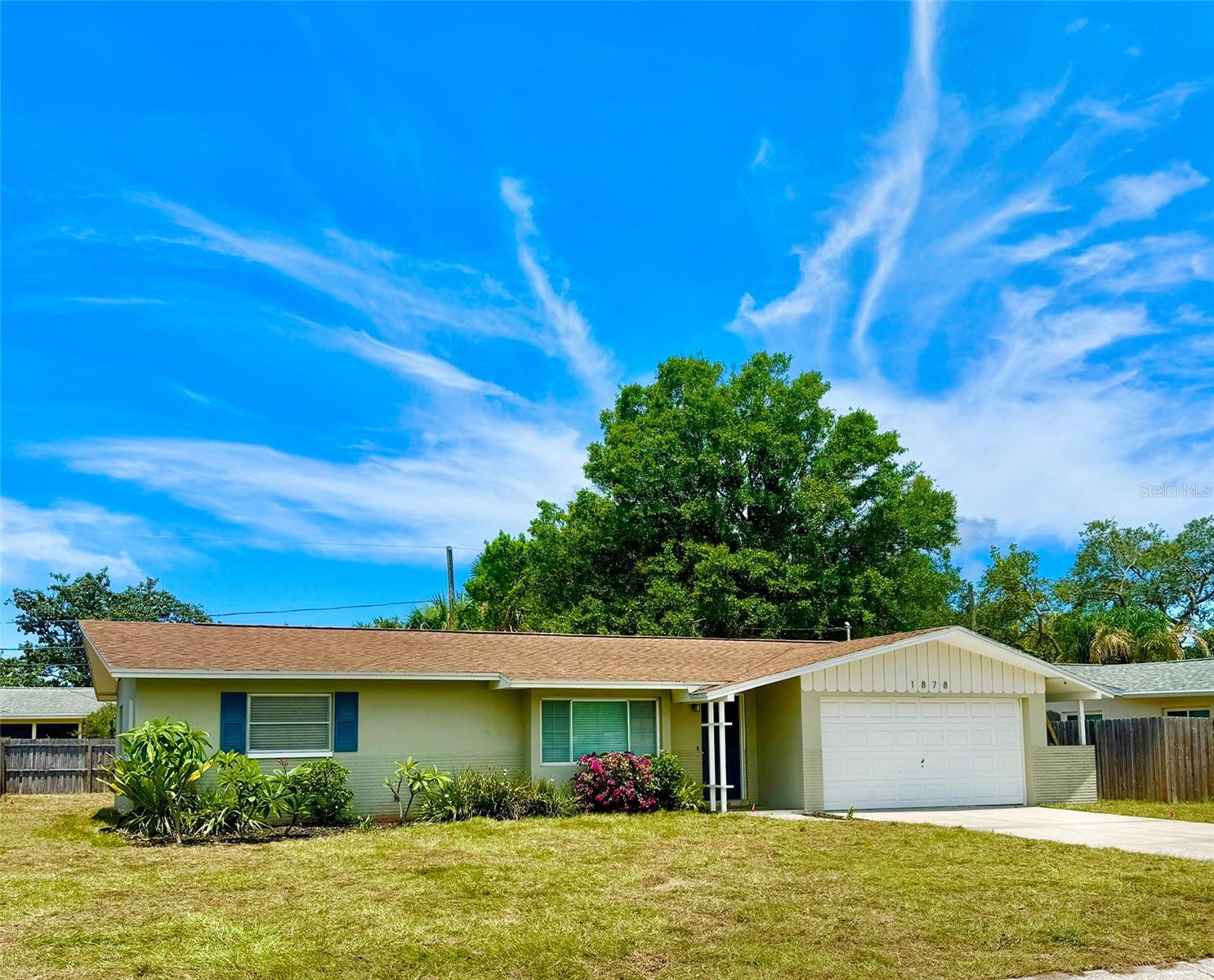 THE AMERICAN DREAM AWAITS.  MOVE-IN READY home with lots of updating in the heart of Clearwater. There is nothing to do here but unpack. The beautifully enclosed lanai creates a useful Florida Room that adds an additional 200 square feet of living area, bringing you to 1316 square feet. The handsome updated kitchen has quartz countertops with stylish wood cabinets and there is an oversized utility/laundry room adjacent to the kitchen. Lighting, painting and interior doors have all been updated and refreshed.  The flooring is very nice; using hand scraped wood engineered planks in the living room and terrazzo in the bedrooms and kitchen. The double pane picture window in the living room brings in lots of light. A custom feature wall with surround sound speakers provides a perfect media wall in the living room AND THE SAMSUNG SMART FLAT SCREEN TV IS INCLUDED. The roof was installed in 2017 and the home has a NEW LAWN with an irrigation system. The spacious fenced back yard boasts an open patio and fire pit for your cookouts and entertaining and leaves you plenty of room for a pool.  You are just a short drive to the beaches and downtown Clearwater but high and dry and not in a flood or evacuation zone. The home is pre-wired for a security system and there are CC cameras around the exterior that will only require you to add a DVR and connect them.  NO HOA, NO DEED RESTRICTIONS. You may also appreciate the generator panel and transfer switch should you ever need it. This home has so much to offer.  Make your appointment to see it today while it is still available.