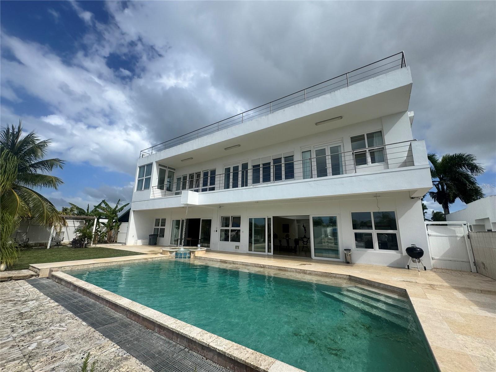 Experience luxury waterfront living in the exclusive gated community of Vistamar Marina in Carolina, Puerto Rico. This spectacular custom-built residence features 5 bedrooms, 6 full bathrooms, and 1 half bath with approximately 6,656 square feet of interior living space plus 2,000 square feet of balconies and terraces.

Designed for both elegance and functionality, the home offers soaring ceilings, an open-concept layout, marble floors, quartz countertops, stainless steel appliances, walk-in closets, a wine cellar, and expansive indoor and outdoor entertaining areas. Enjoy resort-style amenities including a swimming pool, jacuzzi, multiple terraces, and breathtaking marina views.

A standout feature of this luxury waterfront property is the private 80-foot bulkhead dock with direct access to the Atlantic Ocean, making it ideal for yacht owners and boating enthusiasts seeking a marina home in Puerto Rico. Additional unique features include a private heliport, solar power system, backup generator with 500-gallon diesel storage, and a 2,000-gallon water cistern.

Located just minutes from Luis Muñoz Marín International Airport, shopping, dining, beaches, and major services, Vistamar Marina is one of the most desirable waterfront communities in Puerto Rico.

Property sits on a 1,025 square meter lot and is offered furnished, excluding the entrance statue.