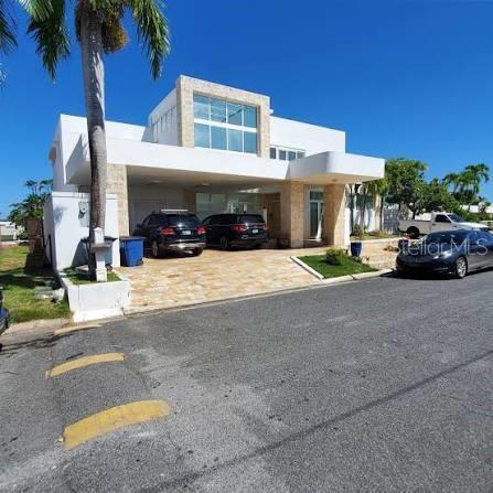 Under contract-accepting backup offers. Experience luxury waterfront living in the exclusive gated community of Vistamar Marina in Carolina, Puerto Rico. This spectacular custom-built residence features 5 bedrooms, 6 full bathrooms, and 1 half bath with approximately 6,656 square feet of interior living space plus 2,000 square feet of balconies and terraces.

Designed for both elegance and functionality, the home offers soaring ceilings, an open-concept layout, marble floors, quartz countertops, stainless steel appliances, walk-in closets, a wine cellar, and expansive indoor and outdoor entertaining areas. Enjoy resort-style amenities including a swimming pool, jacuzzi, multiple terraces, and breathtaking marina views.

A standout feature of this luxury waterfront property is the private 80-foot bulkhead dock with direct access to the Atlantic Ocean, making it ideal for yacht owners and boating enthusiasts seeking a marina home in Puerto Rico. Additional unique features include a private heliport, solar power system, backup generator with 500-gallon diesel storage, and a 2,000-gallon water cistern.

Located just minutes from Luis Muñoz Marín International Airport, shopping, dining, beaches, and major services, Vistamar Marina is one of the most desirable waterfront communities in Puerto Rico.

Property sits on a 1,025 square meter lot and is offered furnished, excluding the entrance statue.