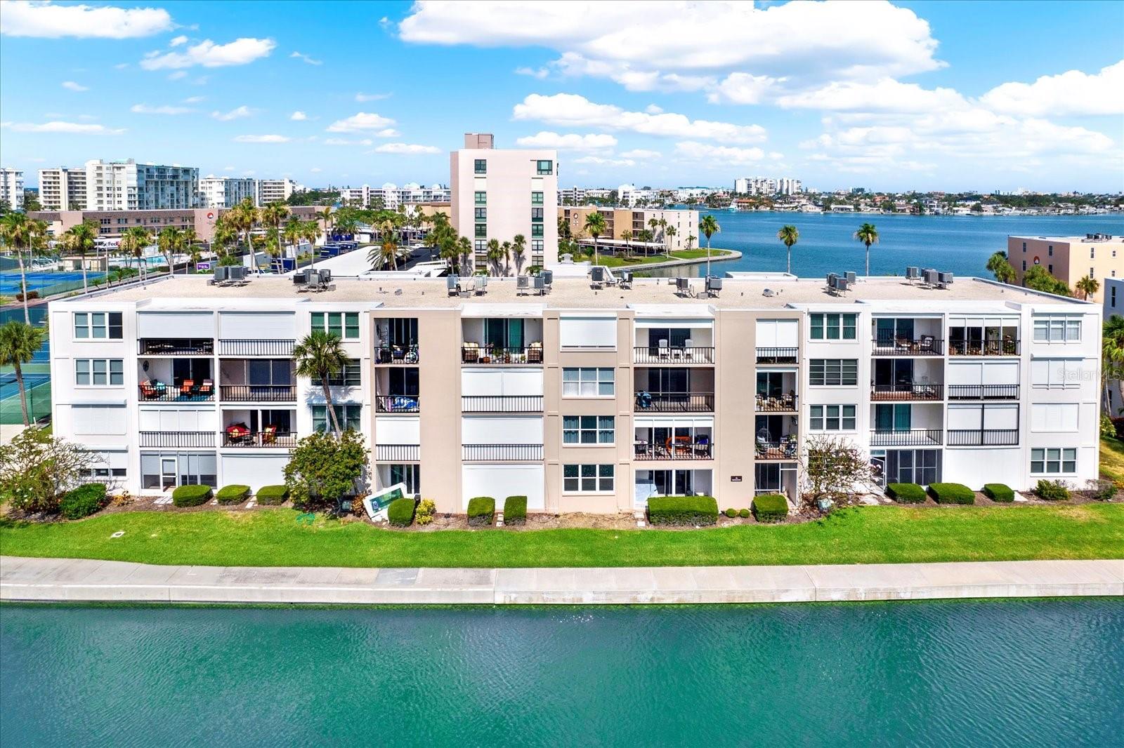 Waterfront Views, Marina Access & Resort-Style Living in Bay Island

Imagine starting your day with coffee on your private balcony overlooking Boca Ciega Bay, watching dolphins play, boats cruise by, and Florida's coastal wildlife put on a daily show. Welcome to Bay Island, one of South Pasadena's premier gated waterfront communities for active adults 55+.

This beautifully maintained third-floor residence offers the perfect blend of comfort, convenience, and affordability. Located just steps from the elevator, this one-bedroom, one-bath condominium features an open floor plan designed to maximize both space and views. Inside you'll find luxury vinyl flooring, granite countertops, a glass tile backsplash, breakfast bar seating, electric hurricane shutters, and a spacious primary bedroom with dual closets.

What truly sets this property apart is the lifestyle. Bay Island offers a rare opportunity to enjoy waterfront living without the premium price tag often found along Florida's Gulf Coast. Residents enjoy access to a private marina with slips available for purchase or lease (subject to availability), making this community especially attractive to boaters, anglers, and anyone who loves being on the water.

Amenities include six swimming pools, two hot tubs, tennis and pickleball courts, shuffleboard courts, a waterfront clubhouse, fitness center, library, billiards room, card rooms, game rooms, barbecue areas, and a scenic 1.5-mile waterfront walking trail that winds through beautifully landscaped grounds.

Located just minutes from St. Pete Beach, Treasure Island, downtown St. Petersburg, the St. Pete Pier, waterfront restaurants, shopping, and entertainment, you'll enjoy easy access to everything that makes Florida's Gulf Coast one of the country's most desirable places to live.

Even better, the recently reduced HOA fee covers nearly everything except electricity, including internet, cable, water, sewer, trash, exterior maintenance, landscaping, exterior and flood insurance for common areas, 24-hour gated security, and full access to community amenities.

Whether you're searching for a year-round residence, seasonal retreat, or a low-maintenance waterfront lifestyle, this is an opportunity to own a slice of paradise at an exceptional value. 

Ask about a 1-0 temporary rate buydown available through a preferred lender for qualified buyers. This program may help reduce the buyer's interest rate and monthly payment during the first year of the loan. Buyers are free to choose any lender. Contact the listing agent for details.