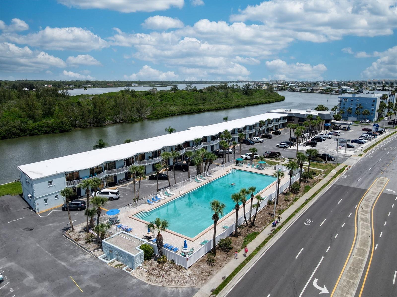 Waterfront paradise on the Intercoastal- turnkey rental opportunity. Enjoy stunning waterfront living in this beautifully renovated first-floor condo overlooking the Intercoastal.  This turnkey property is fully furnished and move-in ready, making it an ideal vacation getaway, seasonal retreat, or income-producing rental. Features include a complete renovation with modern finishes throughout, brand new stainless steel appliances, stylish flooring, elegant plantation shutters, and a space-saving Murphy bed that maximizes comfort and functionality. Relax by the sparkling community pool or simply take in the tranquil water views from your doorstep.  The first-floor location offers easy access and convenience.