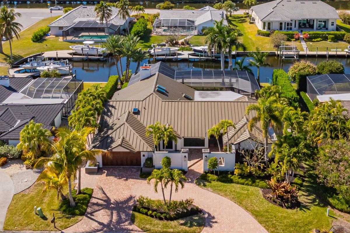 Expertly updated over the past two years, this spectacular direct-gulf-access custom home is presented for your consideration. Situated on an oversized lot with an expansive canal view, you'll be to the open water in minutes. You’ll enjoy 2813 square feet of indoor space that includes 3 bedrooms plus a den, 3 full bathrooms, a large dining/flex space with a vaulted ceiling, and an office nook. From the spacious outdoor living area with western exposure to the carefully curated interior spaces, you may feel as if you designed this property yourself. The home has been extensively restored and renovated – exceeding hundreds of thousands of dollars in outdoor improvements alone. You’ll find newer pool equipment and a picture-window screened lanai that frames the travertine pool deck. The pool tile was replaced, and high-efficiency air conditioning units were installed on elevated platforms. The home was recently painted inside and out, landscaping was added to showcase Florida’s natural beauty, and even the dock has been updated. The installation of an $80,000 metal roof was completed in 2023, as were the addition of impact-resistant windows and exterior doors, including the garage door. The substantial list of interior upgrades is highlighted by the redesigned bathrooms, new skylights, office area with built-in desk, high-efficiency water heater, stainless steel appliances, plus granite countertops and high-end cabinetry throughout the home. Equally perfect as a year-round residence or a second home, this wonderful property can be found in the esteemed Palmetto Point neighborhood. Palmetto Point is conveniently located near Sanibel Island and Fort Myers Beach, minutes away from countless dining and entertainment choices. Common-sense deed restrictions strike the perfect balance between preserving the subdivision's charm and protecting homeowner rights. HOA fees are low and voluntary. Take a moment to view the 3D virtual tour, and see what sets this home apart from others.