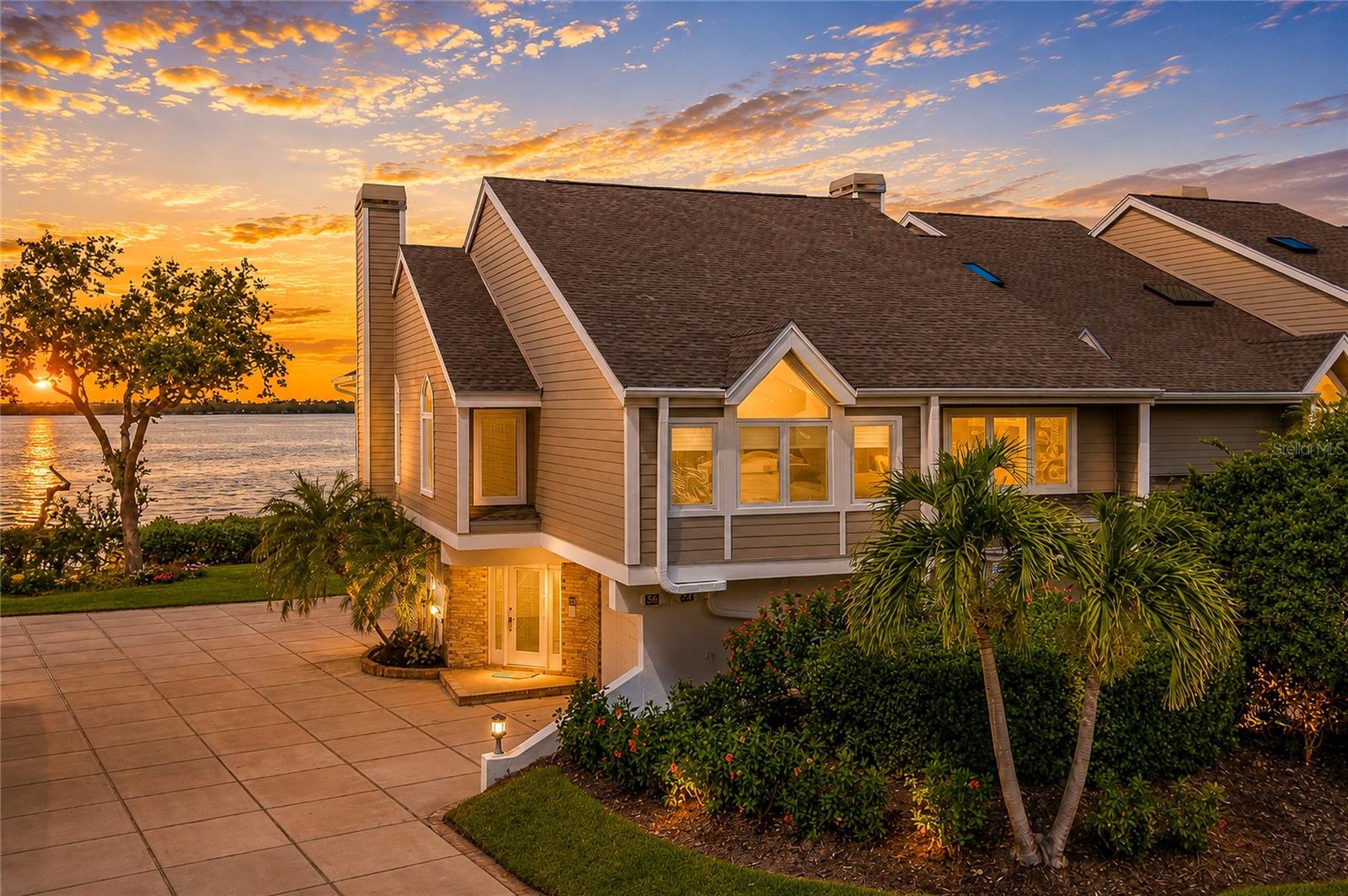 Welcome to your private island retreat in the exclusive, gated community of **Tidy Island**, where breathtaking Sarasota Bay views, exceptional craftsmanship, and resort-style amenities create an unparalleled Florida lifestyle. This beautifully appointed **2-bedroom residence with an office/study** offers an open, light-filled floor plan designed to capture the stunning waterfront scenery from nearly every angle.

The spacious living and dining areas are enhanced by elegant **marble flooring** throughout the main living spaces and a beautiful **fireplace** that serves as a warm and inviting focal point. Custom accent wall murals by renowned local artist **Bob Goodman** add a distinctive touch of coastal sophistication. At the heart of the home is the **chef's gourmet kitchen**, thoughtfully designed with abundant light cabinetry accented by glass display doors, generous workspace, a built-in desk area, and a charming café-style breakfast nook—perfect for casual dining while enjoying the natural surroundings.

The luxurious primary suite serves as a private sanctuary with a spa-inspired ensuite bath designed for ultimate relaxation. The versatile **third-floor loft office/study** features oversized closets, offering the flexibility for a home office, library, hobby room, or additional guest accommodations.

Designed for both comfort and peace of mind, this home boasts an impressive list of recent upgrades, including **two new HVAC systems (2025)**, a **new $30,000 private elevator**, **whole-home hurricane protection**, **high-impact windows and doors throughout**, **LeafFilter gutters with a lifetime warranty**, and a **new roof installed in 2021**.

One of the home's most captivating features is the beautiful **Florida sunroom addition**, complete with designer ceiling fans and air conditioning, providing year-round enjoyment while taking in spectacular panoramic views of Sarasota Bay. Step outside onto the expansive **second-floor terrace**, ideal for morning coffee or evening sunsets, then follow the charming spiral staircase to the lower patio, creating multiple outdoor living spaces perfect for entertaining or simply relaxing in the peaceful waterfront setting.

The oversized **two-car garage** offers exceptional convenience and includes **additional storage space along with a private wine cellar**, providing plenty of room for vehicles, recreational equipment, and prized collections.

Beyond the home itself, Tidy Island offers an extraordinary lifestyle with **24-hour gated security**, two community pools, a clubhouse, fitness center, tennis and pickleball courts, scenic walking and nature trails, a kayak launch, and hundreds of acres of protected natural preserves surrounded by sparkling waters. You'll enjoy the perfect blend of privacy, luxury, and maintenance-free living just minutes from the dining, shopping, arts, and world-famous beaches of Bradenton, Sarasota, and Anna Maria Island.

**Offered furnished or unfurnished**, this exceptional waterfront residence provides the flexibility to move right in or personalize it to your own style.

This is more than a home—it's a rare opportunity to own a spectacular waterfront retreat where every day feels like a vacation.