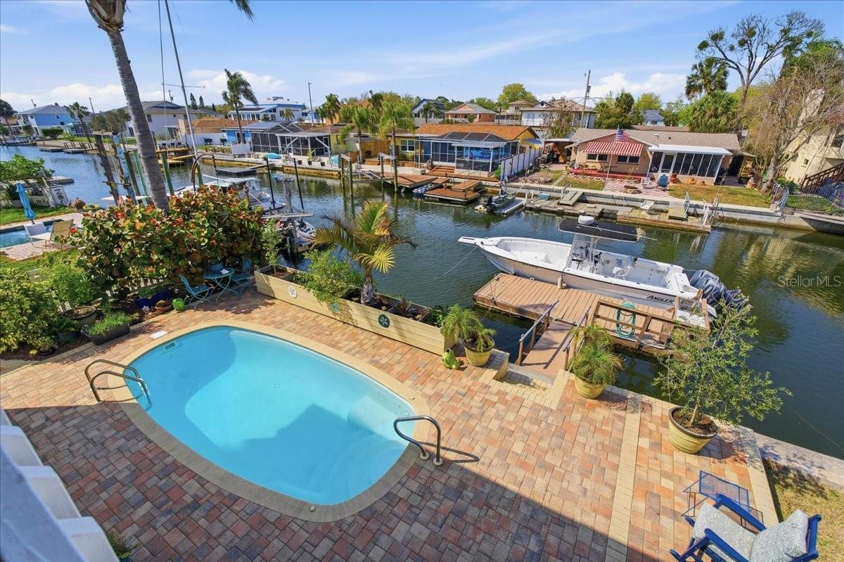 Tucked along a serene saltwater canal, this beautifully updated and well maintained 4-bedroom, 2.5-bath pool home offers the perfect blend of coastal charm and everyday comfort. The abundance of natural light and the open and airy layout creates a warm, inviting atmosphere from the moment you step inside. Enjoy true waterfront living with direct canal access that leads straight to the Gulf of America—ideal for boating, kayaking, or casting a line right from your backyard. The private pool area is perfect for relaxing or entertaining, all while taking in breathtaking sunrises and stunning sunsets that paint the sky each day. Downstairs, a versatile bonus/flex space provides the perfect opportunity for a guest suite, game room, or additional living area, complete with direct access to the pool—seamlessly blending indoor and outdoor living. Recent updates provide peace of mind, including a roof that’s only 3 years old and an AC system just 6 years young—offering worry-free living for years to come. Located in the welcoming and desirable Sea Pines neighborhood, a golf cart-friendly community, this home captures the essence of a laid-back fishing village lifestyle. Spend your days exploring nearby waterways, connecting with neighbors, and indulging in some of the area’s amazing local restaurants such as Inn on the Gulf, Sam's Beach Bar & Get Hooked. Whether you're looking for a full-time residence or a coastal retreat, this property offers the best of Florida living—where every day feels like a vacation.