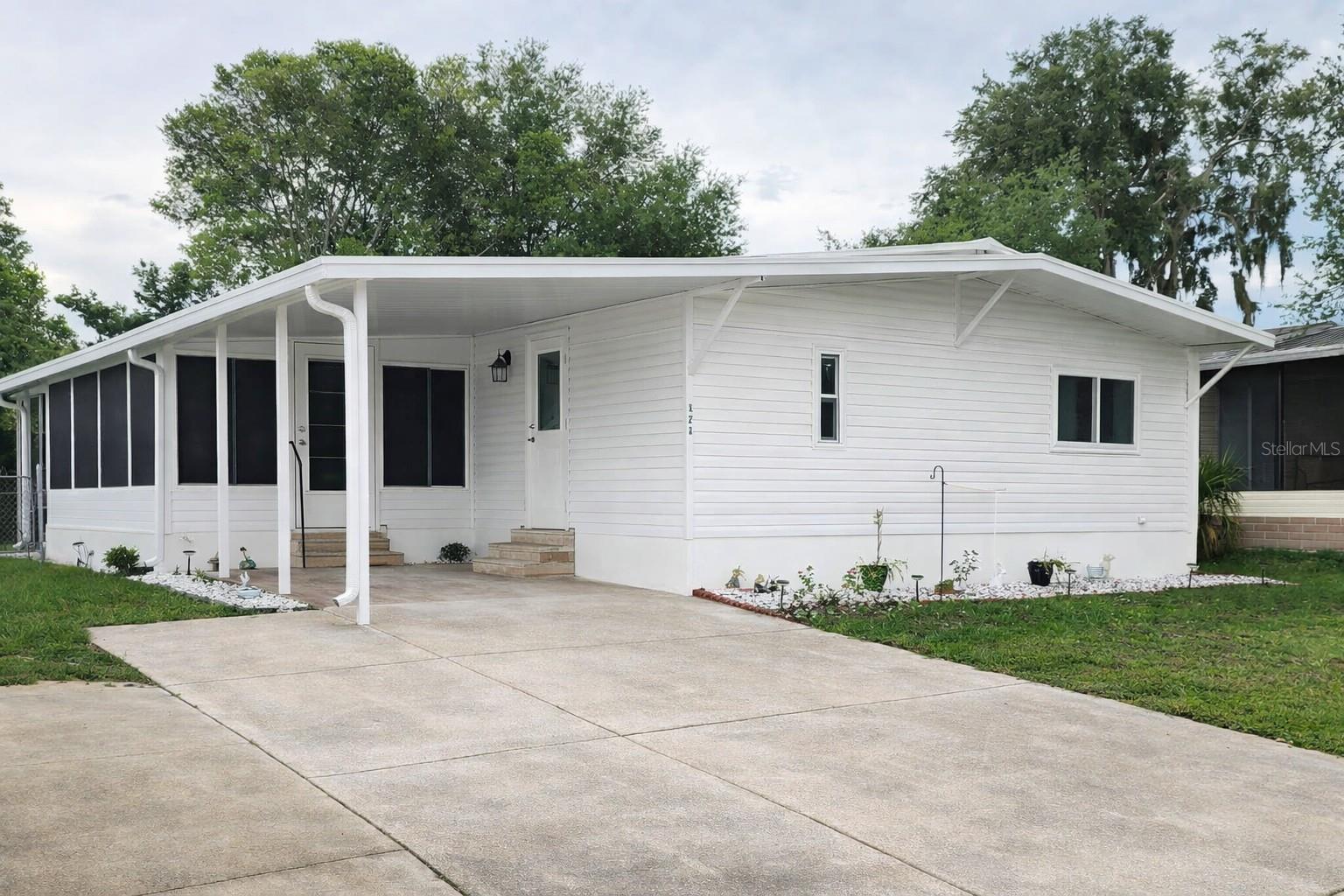 Move-in ready 3-bedroom, 2-bath home located in a river community directly on the St. Johns River. Best of all, there is no lot rent—you own the land! This home features many upgrades, including dual-pane windows, a sliding glass door, an updated front entry door, an oversized enclosed Florida room redone in 2023, A/C replaced in 2017, roof-over completed in 2023, and electrical upgrades with inside and outside panel boxes completed in 2021. The washer and dryer were purchased in 2024 and convey with the home, and the range was replaced in 2025. Ceramic tile in the kitchen and living area makes cleanup easy. The backyard offers a large shed for plenty of storage, along with outdoor patio seating next to the fire pit for relaxing or entertaining. Bring your boat and enjoy the community boat ramp and storage compound. Boat slips are available for sale or rent, and the community also offers a clubhouse with many activities and a swimming pool. Conveniently located close to I-4, approximately 40 minutes from Daytona Beach or Orlando, and just 1.5 miles from the SunRail station for an easy commute. Schedule your private showing today and see all this river community home has for you!