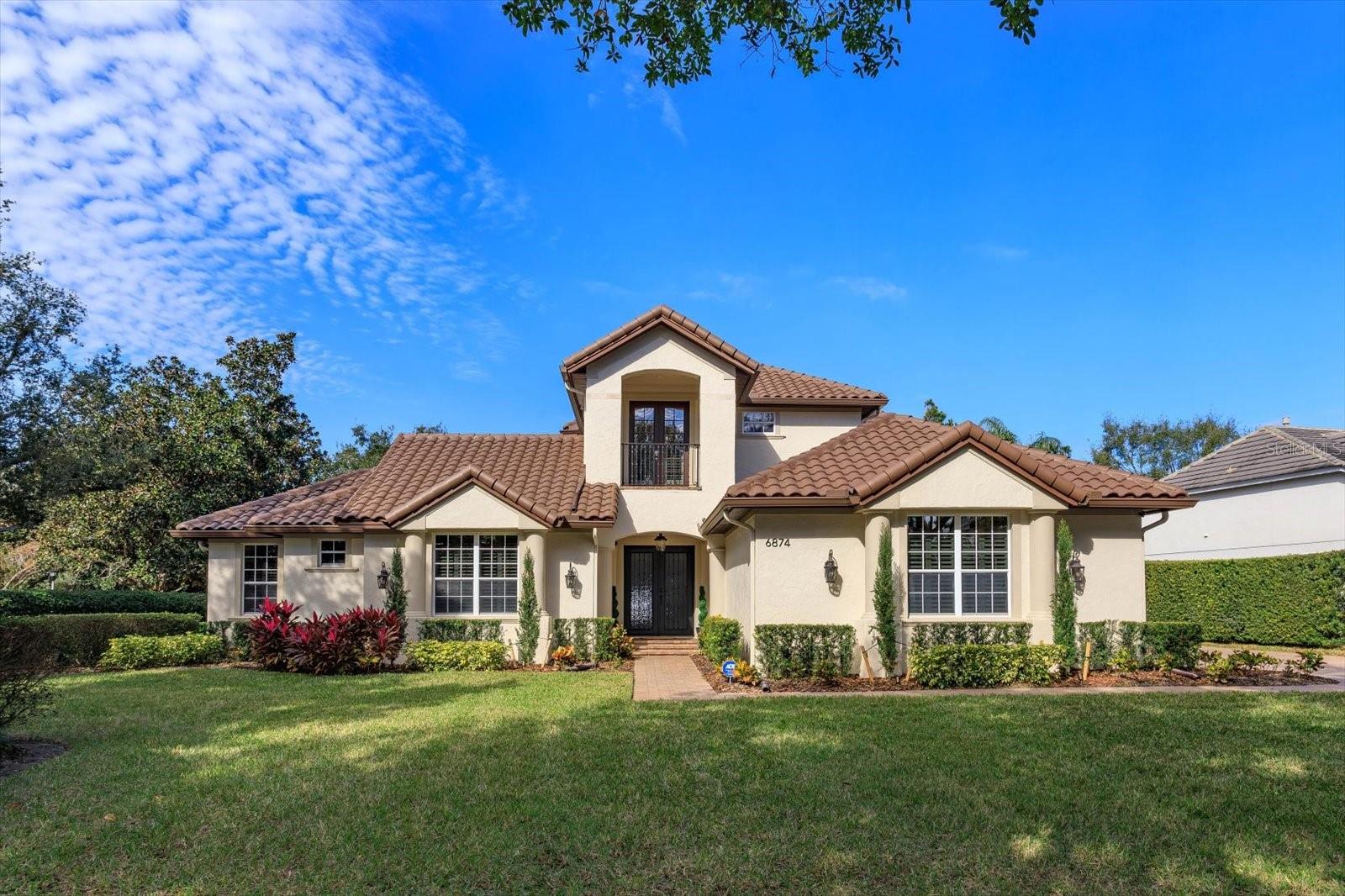 This turn-key, custom-built golf course home is perfectly located in the sought after guard gated golf community of Keene's Pointe.  This stunning 5 bedroom, 5.5 bath, oversized 3 car garage home on coveted Valhalla Way shows pride of ownership throughout. Additional space includes an incredible attached in-law suite with its own bedroom, bathroom, family room and additional private entrance if needed.  Updates to the home itself include a completely renovated kitchen, 2.5 brand new HVAC units and 2 new tankless water heaters provide a dialed in energy efficient heating/cooling experience throughout multiple levels.  A brand-new summer kitchen adjacent to the fully resurfaced screened in lanai pool, brand-new pool equipment with Wi-Fi controls, roof tile sealing that includes a 10-year warranty, all windows treated with UV/privacy tint, and second story attic insulation has been refreshed.  Fresh paint inside and out is surrounded by new light fixtures inside and elegant landscape lighting on the exterior that gives the home tasteful curb appeal at night and is also Wi-Fi controlled.  Additional upgrades include a whole-house water filtration system, garage floor epoxy, a full ethernet home network that provides ample bandwidth coverage for the entire family, an app controlled Lutron lighting system that allows you to create the exact lighting mood to every need.  The master bedroom also has Lutron controlled room darkening shades and the master bedroom closet was fully updated in December 2024. The fully fenced in backyard with hedging has an additional screened in lanai with outdoor built-in fire pit for endless enjoyment in this Windermere golf front estate. The bottom line is this home is immediately move-in ready in a community like no other.