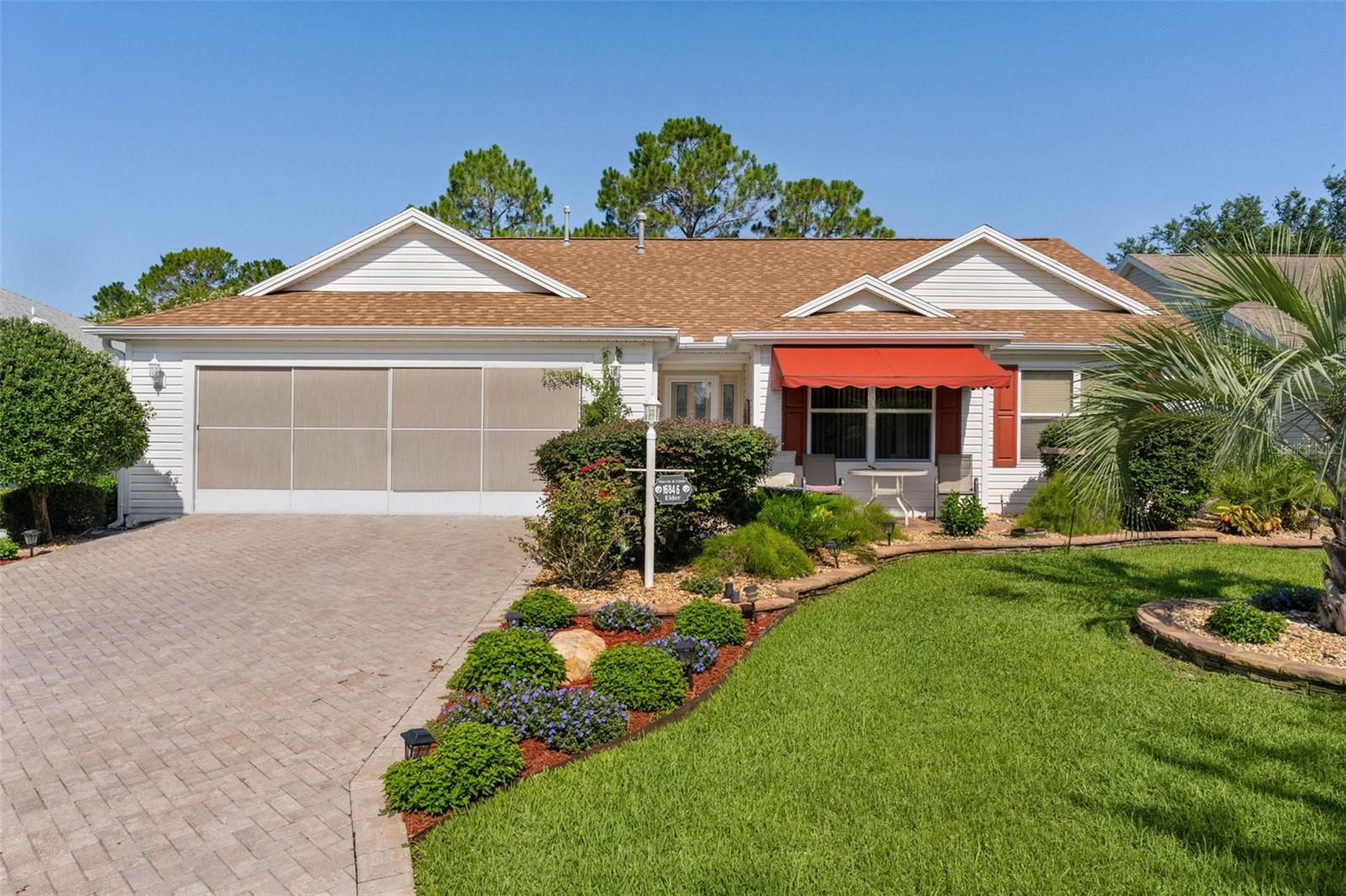 ~NO BOND~ ~2023 ROOF~ ~2024 HVAC~ ~GOLF COURSE VIEW FROM 10x18 FLORIDA ROOM~ ~NO CARPET~ ~BUTTERFLY GARDEN~
Discover exceptional GOLF-FRONT LIVING in this beautifully landscaped WHISPERING PINE model in the Village of CALUMET GROVE! Perfectly positioned with an expansive GOLF COURSE VIEW of the 4th HOLE on NANCY LOPEZ. This 3/2 home provides impressive updates, abundant storage, and multiple indoor-outdoor living spaces surrounded by mature plants, decorative stacked rock accents, and a beautiful PAVER DRIVEWAY. Step inside to find UNIFORM CERAMIC TILE flooring throughout the entire home, creating a seamless and low-maintenance living environment. The bright living room features soaring VAULTED ceilings and ceiling fan, enhancing the open airy feel. The kitchen is both stylish and functional with VAULTED ceiling, GRANITE countertops, STAINLESS STEEL appliances, BACKSPLASH, and a cozy EAT-IN AREA perfect for casual dining. The dining room offers HIGH ceilings and ceiling fan, creating an inviting space for gatherings and entertaining. The spacious primary suite features VAULTED ceilings, ceiling fan, CUSTOM WALK-IN CLOSET, and ensuite bath with WALK-IN shower, DUAL sinks, FRAMED MIRROR and GRANITE countertops. 2 guest bedrooms provide comfortable accommodations with built-in closets, while the guest bath includes a tile tub/shower combination and GRANITE countertops. A standout feature of this home is the FLORIDA ROOM under heat and air, complete with a ceiling fan and built-in shelving, offering versatile year-round living space. Step outside to the CANVAS COVERED BIRDCAGE, with adjacent patio surveying the BUTTERFLY GARDEN where you can enjoy the sun setting over the golf course. The charming front patio provides yet another outdoor space to enjoy your morning coffee. The spacious 2-car garage is loaded with upgrades, including EPOXY FLOORING, storage cabinets and closets, ceiling fan, laundry tub, attic stairs, and convenient slide-across garage screen—ideal for organization and enjoying fresh air year-round. With beautiful views, major updates, and exceptional indoor-outdoor living, this Calumet Grove gem is the perfect place to enjoy All Things Villages. Fabulous access to Calumet Grove and Chatham pools, Nancy Lopez Legacy Country Club, Mulberry Rec Center (pickleball), First Responders Rec Center, and Mulberry Plaza shopping and dining with medical only 5 minutes away on your golf cart.