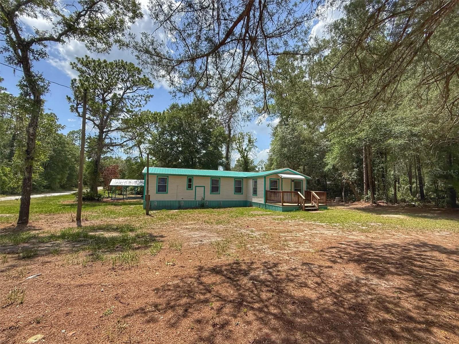 Welcome to peaceful country living in Old Town, Florida! Situated on a spacious 0.47-acre lot, this recently remodeled 3-bedroom, 2-bath manufactured home offers the perfect combination of modern updates, functionality, and small-town charm. Step inside to enjoy the fresh renovations that make this home move-in ready, while still providing a warm and inviting atmosphere. Outside, the property features a large pole barn with a concrete pad, offering plenty of covered space for vehicles, boats, RVs, or outdoor equipment. A spacious storage building in the backyard provides additional room for tools, hobbies, or workshop space, making this property ideal for anyone needing extra storage. Located in the heart of Dixie County, Old Town is known for its peaceful rural setting and easy access to some of North Florida's most beautiful natural attractions. Enjoy nearby boating, fishing, kayaking, and swimming on the Suwannee River, or spend the day exploring the area's crystal-clear natural springs. Chiefland is just a short drive away, offering shopping, restaurants, medical facilities, and everyday conveniences. Whether you're searching for a full-time home, a weekend retreat, or an investment opportunity, this beautifully remodeled property offers comfort, convenience, and the laid-back North Florida lifestyle you've been looking for.