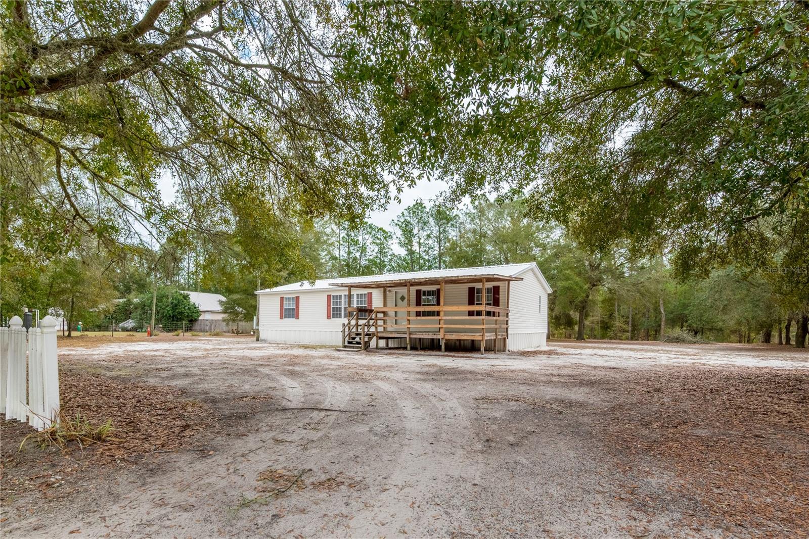 This spacious 3/2 sits on an oversized lot just outside of town, offering the perfect balance of privacy and convenience. Step inside to find fresh interior paint and brand-new carpet throughout, creating a clean and move-in-ready feel from the moment you enter. Brand new updated tile shower adds modern comfort, while the covered porch provides the ideal spot to ease into your mornings or unwind in the evenings. A whole-home water filtration system adds everyday value and peace of mind. Enjoy the privacy of a rural setting with no HOA, with the comfort of paved roads. Perfect central location for quick commuting to Palatka, Orange Park, Jax, or Gainesville. Zoned for ''A'' rated McRae Elementary and ''B'' rated KHHS. Home qualifies for 0 down through DPA. Some photos have been virtually staged.