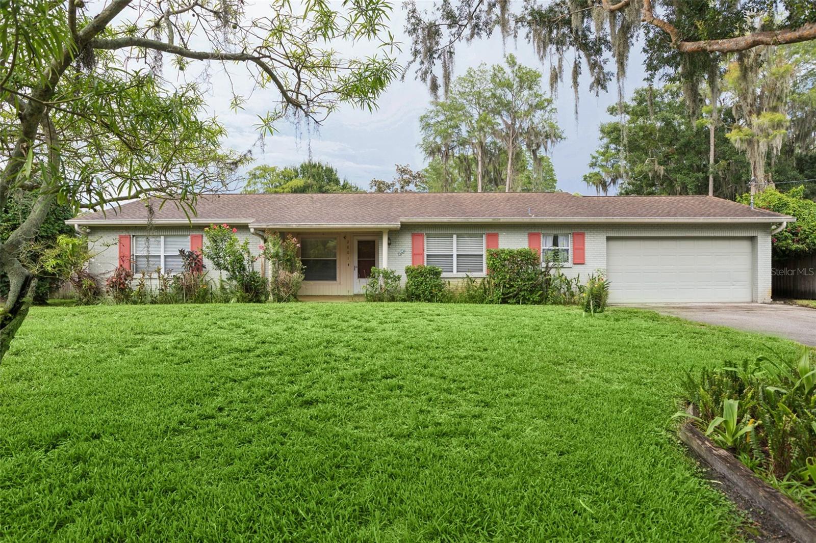 Virtually Staged. Welcome to this serene lakefront home on Wilson Circle in desirable Lutz. Enjoy an optional HOA with no CDD fees and the coveted Steinbrenner High School district. Just minutes to Dale Mabry Highway, this peaceful setting feels worlds away from city life while offering unbeatable convenience.  The home features a flexible floorplan ready for your personal touches and modifications. The updated kitchen offers solid wood cabinets and granite countertops. The primary suite is handicap accessible with a spacious walk-in closet and ensuite bath. Two additional bedrooms share a full bath. Oversized attached 2 car garage has additional room for storage. The large family room opens to a fenced backyard with beautiful views of Lake Wilson. Relax on the screened patio while enjoying nature and lake views. Recent updates include a 2018 roof replacement. The property is served by well and septic systems. Bring your toys — there are no restrictions here.  Experience lakefront living with top-rated schools, welcoming neighbors, and optional community activities. You can update a home, but you can’t change its exceptional location.