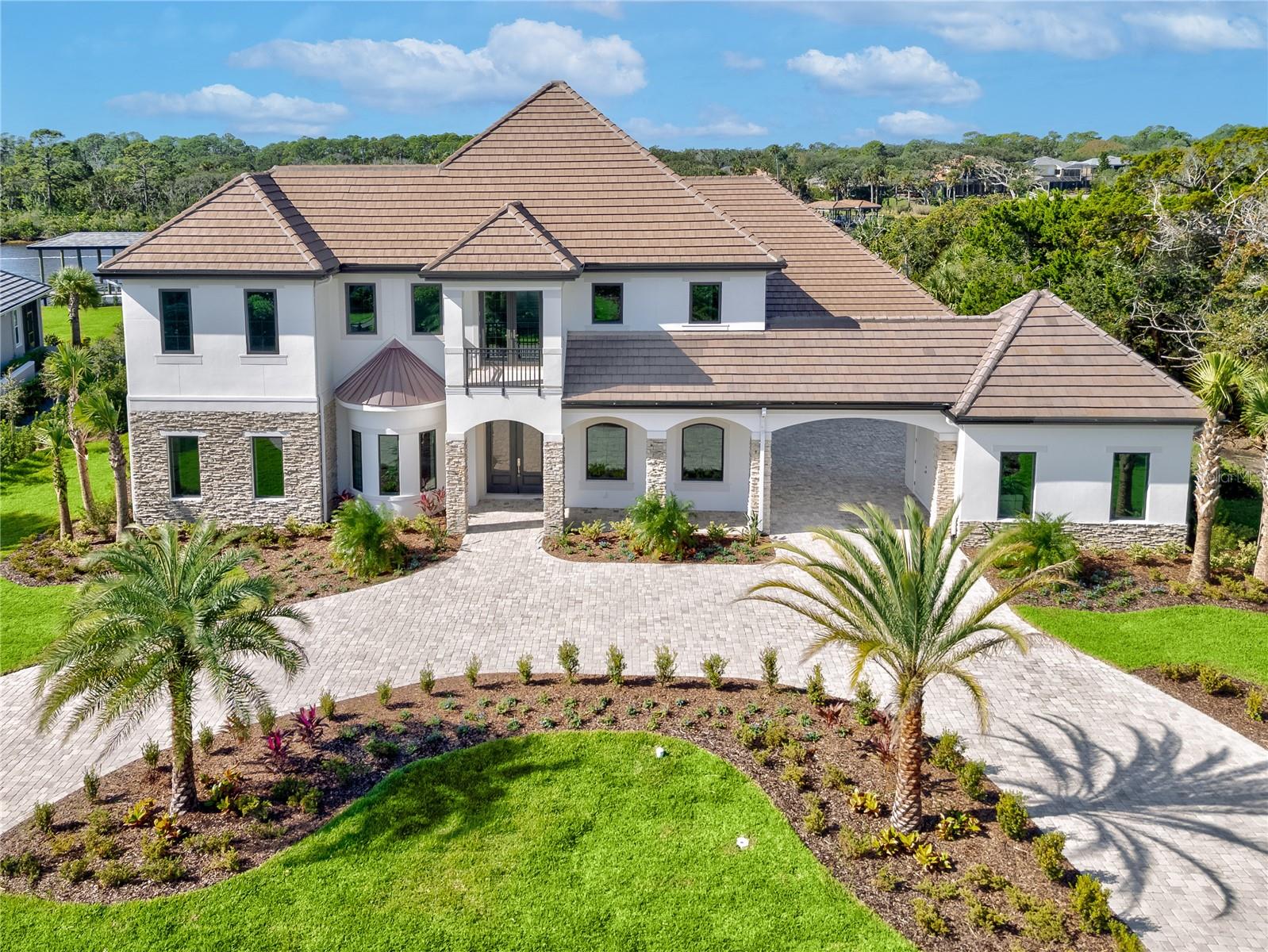One or more photo(s) has been virtually staged. Price improvement! Welcome to your brand new dream home in the exclusive community of Island Estates! This rare find - 6 bedroom 6.5 bathroom beauty with 6672 square feet under air - sits on the Intracoastal Waterway offering mesmerizing views as soon as you walk through the door. The first level boasts the enormous main living space with designer open kitchen concept, sporting Thermador appliances and a huge island for gathering with family and friends. You'll also find the wet bar with glass tile backsplash and wine cooler right off the kitchen for convenience. The 'wall of sliders' brings the outside in with expansive views of the gorgeous pool with spa and the flowing Intracoastal Waterway. The Summer Kitchen is ideal for cooking up meals and dining or just relax pool side on the tasteful travertine tile. The master suite also resides on this floor with eye catching tile and dual showers. The him and her walk-in closets with built-ins provide plenty of storage space. There is also a private door to the pool/spa. The formal dining room, bonus room, office/study and another bedroom located  in the back of the home complete the main floor. Arriving on the second floor by elevator or stairs, you are greeted with more incredible elevated views of the pool and Intracoastal from the second main living space/entertainment area. Step outside with your favorite beverage and watch the sunset from the lanai. Four more large bedrooms, three with en-suite full baths all with dazzling tile reside here. The sellers spared no expense in the building of this masterpiece - PGT windows and sliding doors ensure peak performance and durability. Helical anchors were installed around the interior and exterior of the home. This system exceeds typical foundation and slab construction standards and provides superior structural stability. The AllGuard Elastomeric exterior coating by Dow Coating is yet another upgrade which gives the home a monolithic layer and reflects heat and the elements. Membership to the Hammock Dunes Club is available but not required. Featuring an oceanfront clubhouse with multiple dining options. Two Audobon certified golf courses by legendary designers Tom Fazio and Rees Jones. A 5000 square foot oceanside fitness center, oceanfront pool complex, playground, croquet, tennis, splash pad, pickle ball, bocce and more. This show stopper is a must see. Book your tour today!