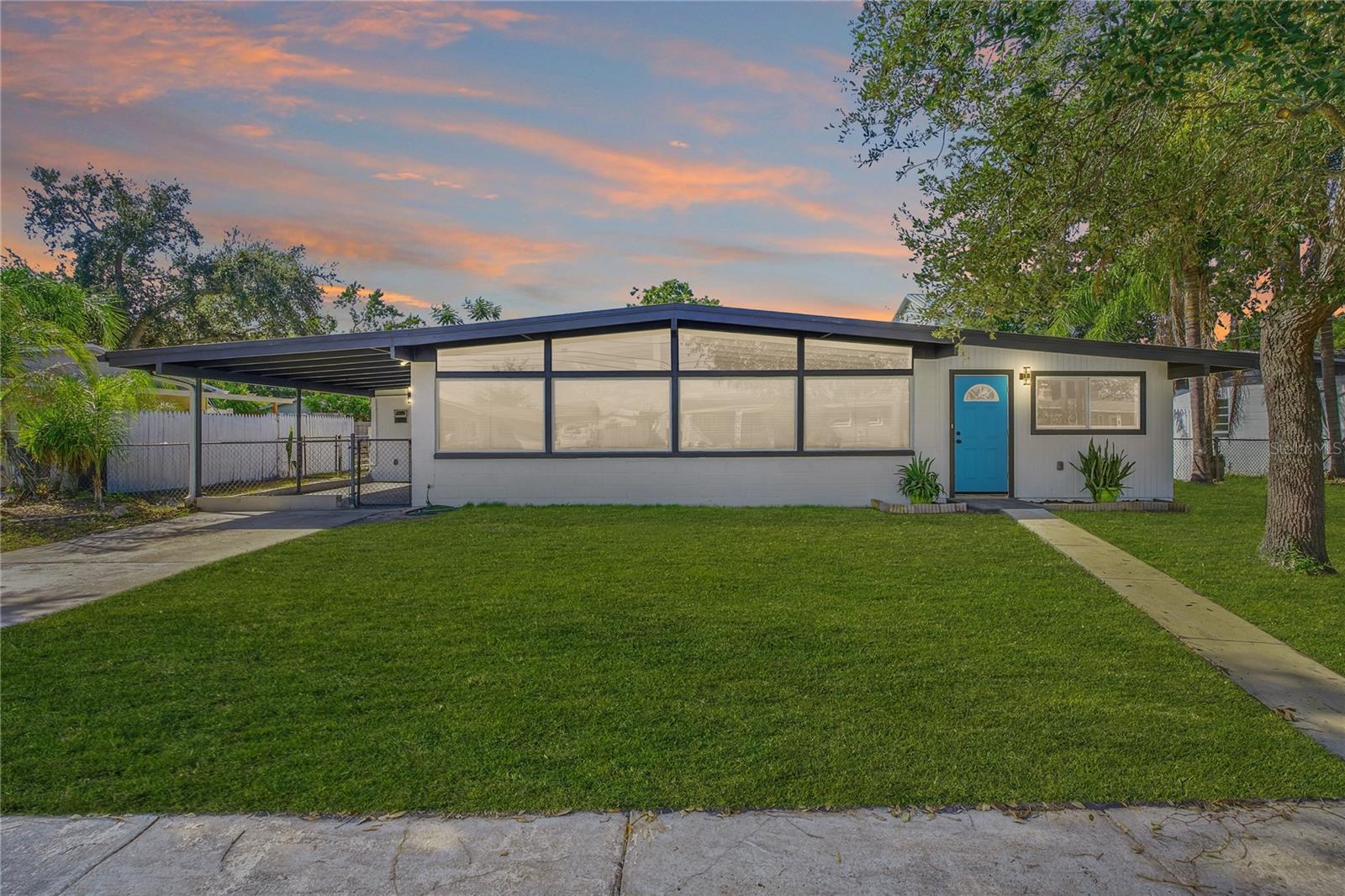 Yes! This beautifully renovated mid-century modern block home actually looks this good in person - no AI staging here! Located in the desirable NO HOA community of Oldsmar Country Club Estates. Timeless character with modern upgrades are inside this 3 bedrooms, 2 bathrooms. Under the exposed beams is 1,344 square feet of thoughtfully updated living space. The fully renovated kitchen features elegant quartz countertops, 42” upper cabinets, and stainless steel appliances, creating a stylish and functional space for everyday living and entertaining. Don't let the floor to ceiling windows fool you eco-friendly design allows a low-cost energy bill. Additional highlights and upgrades include: newer vinyl windows, a 2017 roof, 2023 ductless mini-split system, 2023 hot water heater, and updated electrical in 2025 for added peace of mind. Step outside to enjoy the fully fenced backyard, perfect for pets, entertaining, or relaxing in privacy. The attached carport provides convenient covered parking and additional storage flexibility. Ideally situated just yards from the Oldsmar Boat Ramp with direct access to Tampa Bay, this golf cart-friendly community offers the perfect Florida lifestyle. R.E. Olds Park is a 15-acre dog- friendly waterfront park  featuring a 400 -foot fishing pier, playgrounds, picnic shelters, an amphitheater, and trails with scenic views of Tampa Bay. Named after automotive pioneer Ransom E. Olds, the park hosts numerous community events and offers amenities like volleyball, tennis & pickleball courts & restrooms. With no HOA restrictions, park the boats, RV’s and work trucks with ease. This property is ideal for a first-time homebuyer, seasonal resident, or as an income-producing short-term rental investment opportunity. Annual Flood quote $2,653.34