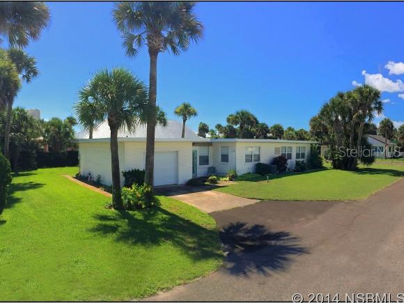 THIS ONE WON'T LAST! Rare North Beach location just 1-block to beach and short walk to shops and restaurants on Flagler Avenue! One-story block home with open floor plan, large bedrooms, and original hardwood floors in great condition. Huge corner lot with 17 tropical palm trees, beautiful yard, and lots of privacy. Over-sized living room is 21' feet long, and entire house boasts lots and windows and natural light. Extra large single-car garage perfect for another full bath. A rare find at a great price that is sure to move quickly!! ;Water: City