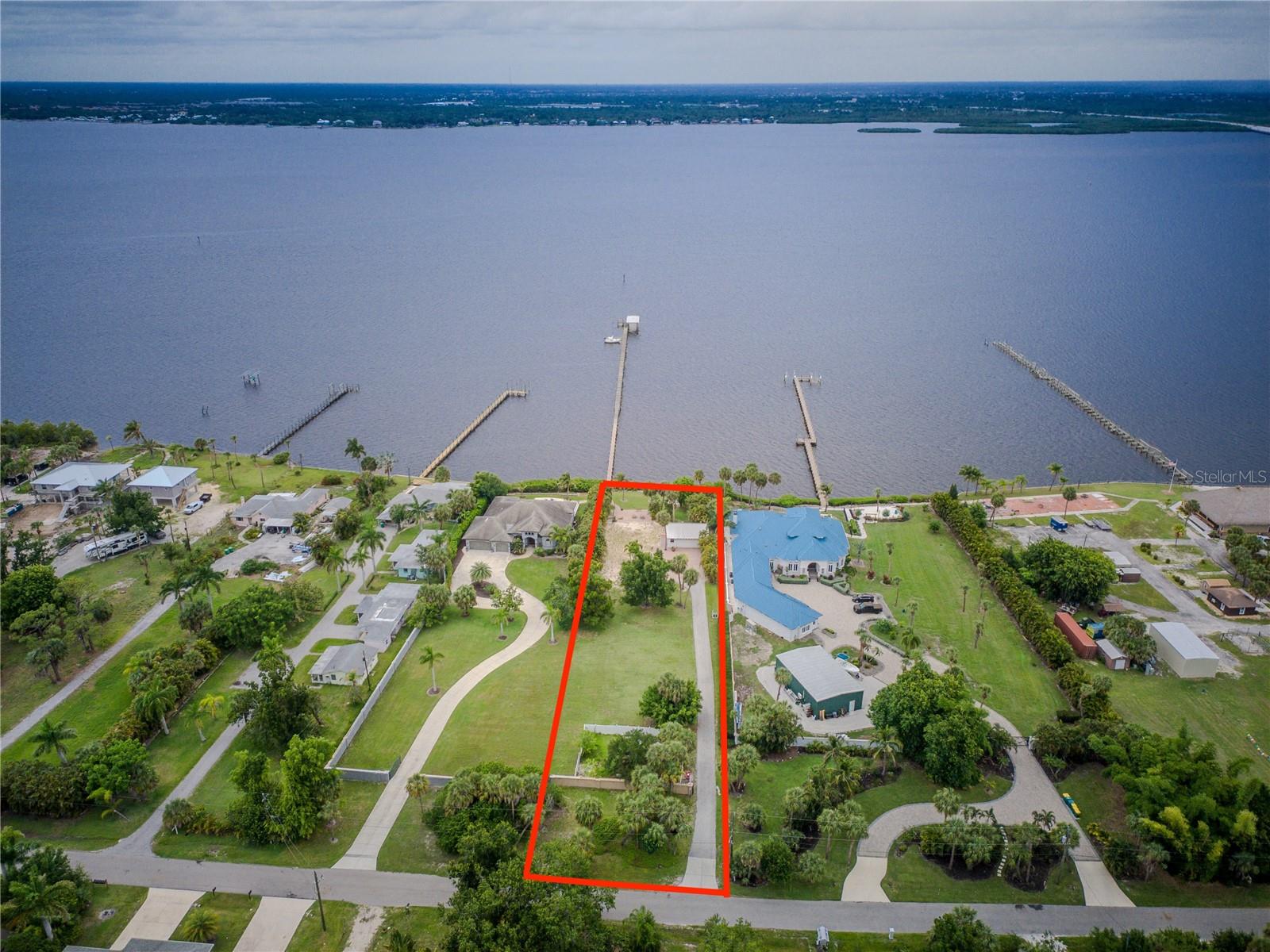 Rare Opportunity Meets Unmatched Potential! Welcome to 25472 Shore Drive — one of the last remaining waterfront homesites on the iconic Peace River in the heart of Punta Gorda. This extraordinary parcel offers nearly one acre of pristine riverfront land with 100 feet of direct Peace River frontage, full riparian rights, and an existing 630 feet shared dock — delivering immediate water access from day one. Unlike typical waterfront parcels limited to a single residence, this property’s coveted RMF-10 zoning unlocks a world of possibilities: build your custom-designed luxury elevated riverfront estate, or capitalize on the income-producing potential of a boutique multifamily with stunning water views that Airbnb guests and long-term tenants will compete for. The numbers speak for themselves — neighboring improved waterfront homes on Shore Drive command prices exceeding $2,000,000, making this a genuine equity-building opportunity from the moment you close. Enjoy world-class fishing directly from your dock with legendary catches of snook, redfish, tarpon, and trout in the Peace River and Charlotte Harbor beyond — or cruise out to the Gulf of Mexico minutes away by boat. As the sun sets over the river each evening, the breathtaking panoramic water views create a backdrop that simply cannot be replicated. Just one block away, the beloved waterfront Elks Lodge restaurant adds walkable dining and entertainment to an already exceptional location. Minutes from vibrant downtown Punta Gorda, 25472 Shore Drive is not just a property, it is a legacy investment in one of Southwest Florida’s most desirable and rapidly appreciating waterfront corridors. Opportunities like this do not come twice!