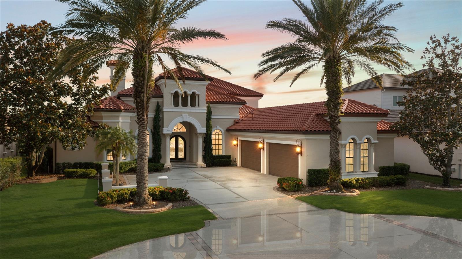 * Waterfront Luxury in Winter Garden’s Signature Lakes * Set on 2 rare acres with 92 feet of Lake Hancock frontage, this home offers unmatched waterfront living. This impeccably maintained estate offers refined living and stunning views in Winter Garden’s premier community. With soaring ceilings, floor-to-ceiling windows, and walls of glass that open on both levels, the home blends light, space, and seamless indoor-outdoor living. The formal living room features a fireplace and sweeping views of the pool and lake. Just off the main entry, the formal dining room features dramatic molding and a statement chandelier, creating the perfect backdrop for unforgettable dinners. The adjacent home office boasts rich wood flooring, offering a quiet space for work or study. The gourmet kitchen is a chef’s dream, featuring a freestanding Wolf dual-fuel gas range, Sub-Zero refrigerator, built-in Wolf oven and microwave, wall-mounted pot filler, expansive island, custom cabinetry, and a large walk-in pantry-ideal for both intimate meals and large gatherings. The main primary suite is a serene lakeview retreat, complete with a spa-inspired bathroom, dual vanities, soaking tub, oversized walk-in shower, and custom California closets. Also on the main floor, a second lake-view suite provides a private escape for guests or multi-generational living, featuring its own Jacuzzi tub, separate shower, and custom walk-in closet. The third main-floor bedroom features an extended closet with a charming under-stair hideaway nook.  It's a unique, flexible space perfect for play, storage, or even a cozy reading den.
The second level media and game room are thoughtfully designed for both relaxation and entertainment. Featuring a custom-built stage, home theater setup, and a wet bar with microwave, beverage cooler, and glass-front cabinets, this a true entertainment haven! Folding French doors at the corner open fully to a spacious covered balcony, offering breathtaking panoramic views of the lake, pool, and dock.
Step outside to a covered summer kitchen with built-in grill, cooktop, stone hood, and bar seating-ideal for lakeside barbecues. A spacious porch overlooks your private resort-style retreat.  Anchored by a stunning 38x22 custom pool, the backyard is a showpiece of elegant design and effortless functionality. Your private outdoor retreat is designed for indulgence and ease. Surrounded by expansive travertine decking, lush tropical landscaping, and unobstructed lake views, it's the perfect setting for both serene escapes and lively entertaining. Just steps away, a private cabana features a full summer kitchen with ice maker, bathroom, and outdoor shower—offering everything you need for elevated living in true Florida style.
A private dock with electric lift gives you direct access to Lake Hancock, a 479-acre recreational lake perfect for boating, watersports, and fishing. Whether you're enjoying a peaceful morning on the water or catching Disney fireworks at night, this home delivers unmatched lakefront living.
Located in Independence, one of Winter Garden’s most amenity-rich communities, with two resort-style pools, two fitness centers, scenic trails, community boat ramps, tennis and basketball courts, dog parks, and two beautiful clubhouses. HOA dues include high-speed internet and basic cable. Just minutes from Hamlin Town Center, less than 10 minutes to Disney, and with easy access to the 429 for seamless travel throughout Central Florida.