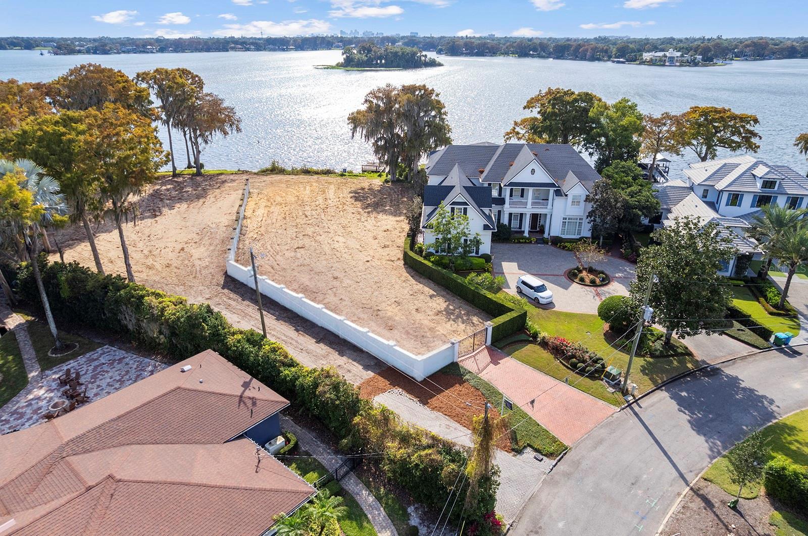 Wonderful lakefront lot opportunity to create a custom legacy estate on Lake Maitland, part of the Maitland-Winter Park Chain of Lakes. Lakefront homesites are becoming increasingly rare, and this offering is truly special. Tucked away on a quiet street, the property enjoys a very private setting with the ability to be gated, along with sweeping southern lake views that capture both sunrise and sunset in equal measure.

Photos #9–#14 illustrate a thoughtfully conceived design concept created specifically to complement the lot’s dimensions and orientation, while maximizing panoramic lake views and indoor-outdoor living. With approximately 18,500 square feet of upland to be developed, there is potential to build a residence of approximately 7,500 square feet (roughly 40% of the lot size). The site has already been cleared and is ready for construction, allowing a future owner to move seamlessly from vision to reality.

Property enhancements include a seawall, gated front entry drive, and a covered boat lift with dock—offering immediate access to boating, fishing, and water sports. This is a rare canvas for a multi-generational lakefront estate, where architectural distinction meets a lifestyle centered on the water. Days may be spent wakeboarding, casting a fishing line, or relaxing poolside as boats glide across the lake, while evenings invite effortless cruises across the water to the Winter Park Racquet Club for dinner, cocktails, and social gatherings.

Nestled in a secluded enclave of Maitland, the property is just minutes from the boutiques and dining of Park Avenue, with convenient access to downtown Maitland, major roadways, and the greater Orlando area.

Note: The adjacent lakefront property, 127 Whitecaps Circle (24,472 square feet, approximately 0.56 acres) is also listed for sale, presenting a rare opportunity to combine two neighboring lakefront parcels and create a private compound for family or friends. All building calculations and development potential to be confirmed with the City of Maitland and the buyer’s builder and architect during due diligence, as any referenced figures are preliminary and not officially verified.
