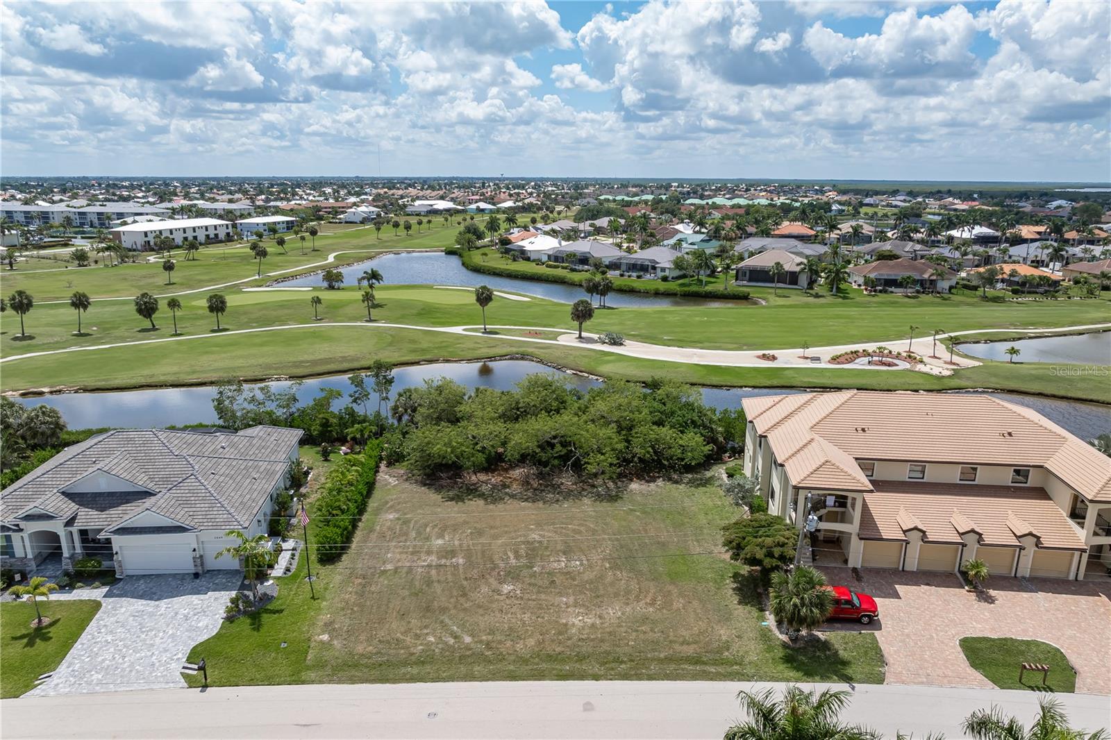 PRIME PUNTA GORDA ISLES LOT W/WATER, GOLF & SUNSHINE VIEWS - Oversized, golf-course lot in Punta Gorda Isles w/a fabulous view of a lush pond as well as the 9th fairway of St Andrews South golf course. Lot is zoned for multi-family but can be used for a single-family residence. Located on a quiet street in PGI, the property is perfect for a large home, duplex or small condo development. It offers a wonderful water view across the pond to the manicured fairway beyond. Enjoy watching the golfers pass by behind the home throughout the day. Surrounded by a mix of newer custom homes and well-maintained residences, this property provides plenty of room to design the home you’ve always envisioned, with SPACE FOR A LARGE OUTDOOR LIVING AREA, POOL, **AND** THREE-CAR GARAGE - you don't have to choose between them. The southeastern rear exposure will fill your future lanai and pool area with morning sun and bright natural light throughout the day. Lot is walking distance to the St Andrews South clubhouse & the driving range. Punta Gorda Isles is a deed-restricted waterfront and golf community with miles of sidewalks connecting you not only to St. Andrews South Golf Club but numerous parks, Isles Yacht Club, Fishermen's Village and historic downtown Punta Gorda. Shopping, restaurants, and waterfront activities are all just minutes away. Claim your spot in paradise & start living the Florida dream.