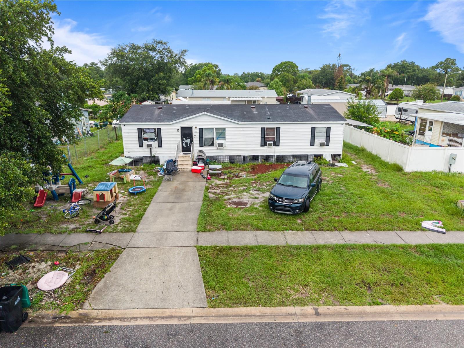 Located in East Orlando, this manufactured home offers a spacious layout with an open-concept living room, eat-in kitchen, multiple bedrooms, and a sizable yard. The property presents an excellent value-add opportunity for investors seeking a rental, flip, or long-term hold. With a functional floor plan and solid living space, this property has strong upside potential after cosmetic improvements and is conveniently located near major highways, UCF, shopping, dining, and everyday amenities.