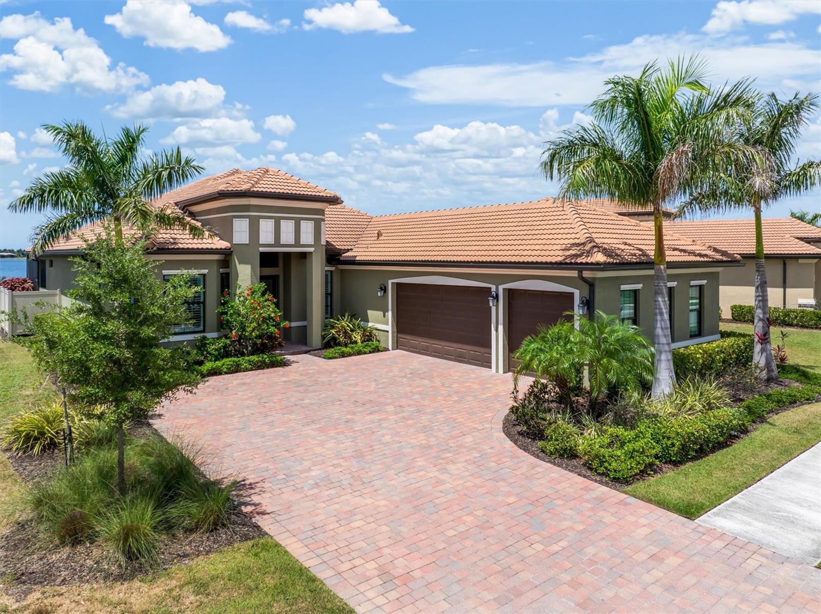 Experience the perfect blend of luxury, privacy, and Florida lifestyle at 553 Maraviya Boulevard, located within the highly sought-after Toscana Isles community of Nokomis. Rarely does a home combine an oversized waterfront homesite, private resort-style outdoor living, and proximity to Venice’s award-winning Gulf beaches in one exceptional offering. Positioned on one of the community’s premier oversized homesites, this exceptional residence showcases expansive long-lake views and a setting designed for both elegant entertaining and everyday enjoyment.  From the moment you enter, you’ll appreciate the thoughtful design and upscale finishes throughout. The open-concept floor plan features tray ceilings, crown molding, designer details, and an abundance of natural light. Tile flooring flows throughout the main living areas, while the bedrooms offer warmth and comfort. At the heart of the home, the gourmet kitchen is beautifully appointed with quartz countertops, a spacious island, gas range, pantry, and butler’s pantry. Seamlessly connected to the great room, it creates an inviting atmosphere for gathering with family and friends. The owner’s suite offers a private retreat with custom walk-in closet built-ins, dual vanities, and a spacious walk-in shower. Additional conveniences include an interior laundry room complete with cabinetry and utility sink. Step outside to your own private waterfront retreat featuring Travertine decking, a heated saltwater infinity-edge pool that appears to blend seamlessly into the expansive long-lake views beyond, and a custom stone outdoor kitchen complete with a stainless-steel gas grill, sink, and refrigerator. The expansive screened lanai provides the perfect backdrop for morning coffee, sunset cocktails, or entertaining guests while enjoying the beauty and tranquility of the waterfront setting. Built with quality and peace of mind in mind, the home includes hurricane-impact windows, a hurricane-rated garage door, propane service, a Navien tankless water heater, and a water softener. Toscana Isles is highly regarded for its distinctive Tuscan-inspired architecture, beautifully maintained grounds, and more than 200 acres of interconnected spring-fed lakes. Designed around an active resort-style lifestyle, the community features an impressive 8,000-square-foot lakefront clubhouse, stunning infinity-edge pool, fitness center, pickleball and tennis courts, bocce courts, dog park, and a vibrant social calendar coordinated by an on-site lifestyle director. Residents also enjoy fishing, kayaking, and canoeing throughout the community’s expansive lake system. A gated entrance provides added privacy and peace of mind.  Ideally positioned just east of Interstate 75 off Laurel Road, the home offers convenient access to some of Southwest Florida’s most desirable destinations. Enjoy being approximately 10 minutes from Nokomis Beach, Venice Beach, and the shops, restaurants, and charm of historic downtown Venice, while Sarasota’s renowned arts, dining, shopping, and cultural attractions are only about 20 minutes away. Because luxury is more than a home—it’s a lifestyle. INFORMATION IS DEEMED RELIABLE BUT NOT GUARANTEED…TO BE VERIFIED BY THE BUYER AND/OR BUYER'S AGENT.