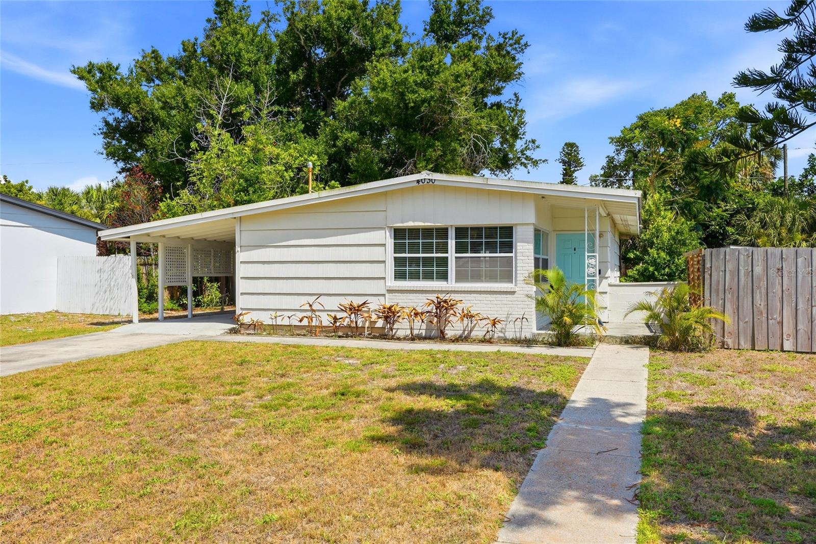 Charming mid-century modern home perfect as a primary residence, first home, or second home getaway, located just minutes from downtown St. Petersburg, Gulf beaches, and the scenic trails of Boyd Hill Nature Preserve. This home offers 2 bedrooms, 1 bathroom, and a versatile bonus room ideal for a home office, guest space, or potential third bedroom. New tile flooring flows throughout, and the kitchen impresses with stainless steel appliances, wood cabinetry, granite countertops, and a spacious walk-in pantry. The bathroom has been refreshed with an updated vanity and modern lighting. Step outside to a Florida-style screened patio featuring warm pine ceilings and walls, a welcoming space for relaxing or entertaining year-round. The oversized 8,825 sq ft lot offers endless possibilities: expand the existing home, add a pool, create an outdoor entertaining area, or store your boat. The spacious backyard shed is a standout bonus, easily transformed into a home office, art studio, gym, or workshop. A public boat ramp is just down the street with easy access to downtown St. Pete waterfront restaurants and local sandbars. Close to Coquina Key Park, featuring a playground, tennis courts, basketball courts, and a dog park. This home is high and dry with no flooding during Hurricanes Helene or Milton!