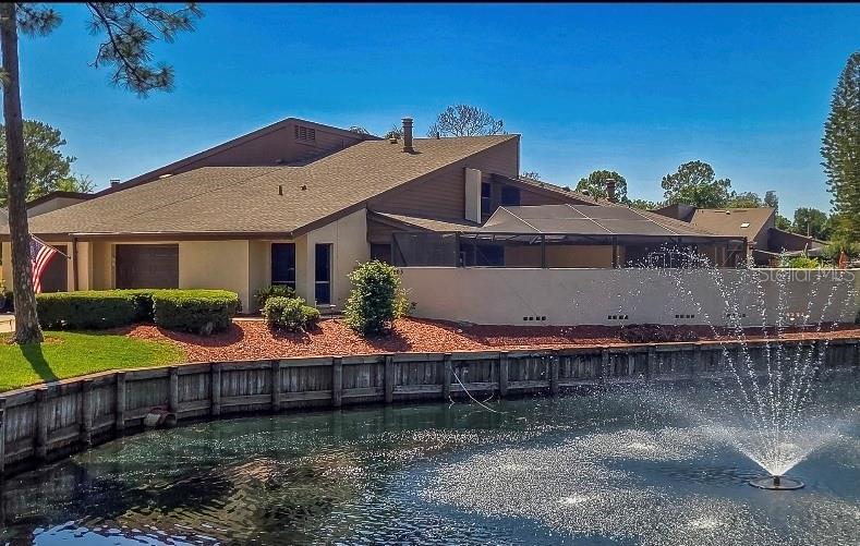 Welcome home to this beautifully updated and well maintained 3-bedroom, 3-bath home offering 1,820 square feet of stylish living space and one of the largest floor plans in the community! Perfectly blending comfort, elegance, and low-maintenance living, this rare Carrollwood gem is located in one of the area’s most sought-after neighborhoods.

From the moment you step into the expansive private gated and screened courtyard, you’ll immediately feel the peace, privacy, and charm this home offers. Inside, soaring vaulted ceilings and a stunning marble-surround wood-burning fireplace create a warm atmosphere. The dining area is highlighted by a beautiful chandelier and flows seamlessly into the kitchen featuring Corian countertops, wood cabinetry, breakfast bar seating, and beautiful appliances.

The spacious first-floor primary suite offers comfort and convenience with a large walk-in shower and private French door access leading to the oversized sunny lanai, the perfect space for morning coffee, entertaining guests, gardening, or simply relaxing outdoors.

On the opposite side of the home, you’ll find a secondary bedroom and full bath ideal for guests or family members. Walk up the striking spiral staircase which leads to the upstairs loft-style third bedroom with its own full bath, making it the perfect guest suite, executive office, media room, recreation space, or private retreat.
Additional highlights include: FREE 1-Year Home Warranty ($650 Value), New 200-Amp Electrical Panel Upgrade (March 2026), New Garage Door, 1-Car Garage + Driveway + Guest Parking, Ample Storage + Attic Access, Low HOA Includes Water, Sewer, Lawn Maintenance, Community Pool & Clubhouse, NO CDD Fees, Picturesque Lake with Tranquil Fountain Views

Perfectly located just minutes from Citrus Park Mall, top-rated schools, churches, hospitals, restaurants, Tampa International Airport, Downtown Tampa, and the Gulf Coast’s award-winning beaches.