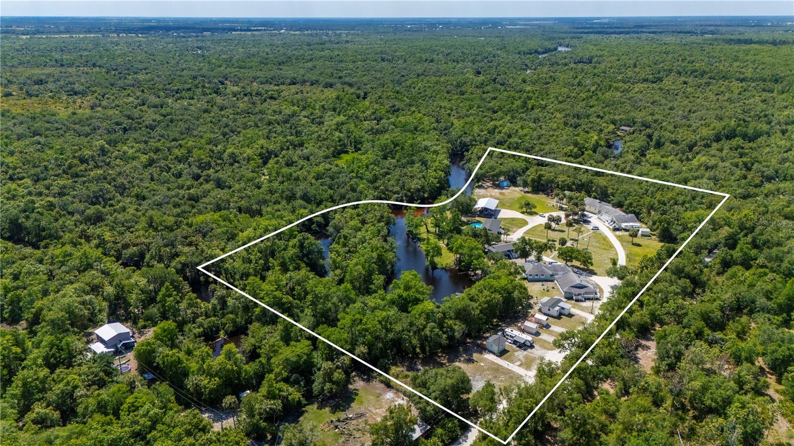 TURNKEY Waterfront Income Property | $237,000+/- Verifiable Gross Income | Offered at 7% Cap Rate | 16 Rental Income Units | 10 Buildings | 12.2 Acres | GULF ACCESS | One of the FIRST times available for private ownership purchase, previously sold by State of Florida. FULLY RENOVATED, with numerous NEWER ROOFS, NEW KITCHENS, APPLIANCES, HVACS, FLOORING, PAINT INSIDE AND OUT and more.  Horse Creek Retreat is an established Airbnb business with a 4.99-star rating and 300+ reviews, providing immediate cash flow. Rare opportunity to acquire a fully operational, income-producing waterfront retreat with over 950 linear feet of Gulf access frontage on 12.2± acres. This unique property features 16 income-producing units across 10 structures, offering a diversified mix of short-term rentals, long-term tenants, and group accommodations. Improvements include a 9-unit Dormitory Building, a 7-bedroom Retreat Center ideal for large groups, Cafeteria Building, Waterfront Cottage and (3) Tiny homes, and income-producing (2) RV sites, Utility Building with Workshop, Large Pole Barn, and a Storage Building. Significant value-add potential remains, including a large waterfront cafeteria building with commercial kitchen (ideal for events or additional income) and an fully renovated owner’s residence that can be rented for added revenue. AGRICULTURAL Zoning Approved Uses: Agri-tourism, Bed & Breakfast, Vet Hospital, Animal Breeding/Training, Livestock sales, Fruit/Nut Production, Egg/Milk Production, Barns, AG equipment storage, Beekeeping, Private Dock, Commercial Fisheries, Family Day Care, HORSES/ANIMALS, and more! Property features include a private BOAT RAMP, serene canal frontage, livestock pen, and fully Fenced. "Off the Grid" potential with a private commercial Wastewater System & Water Treatment Facility. Conveniently located near I-75 within 10 min and Downtown Punta Gorda while offering privacy and natural surroundings adjacent to thousands of acres of preserved land. Ideal for investors, retreat operators, or those seeking a scalable hospitality business with strong in-place income and upside potential. Don't miss this RARE opportunity - schedule your tour today!