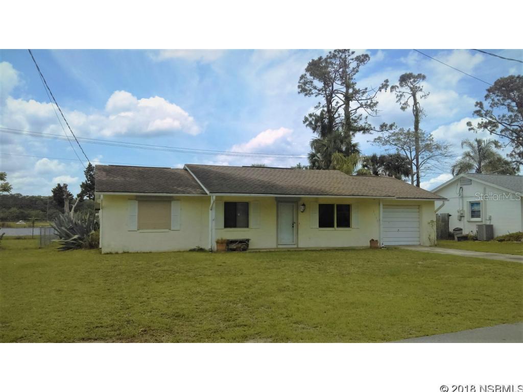 CB home nestled on a pond front property with great views of the water. Relax and enjoy the water breeze from the large backyard with plenty of room for a new pool. This listing features 2 Bedroom, 2 Full Baths, 1 car garage, front and back porch, large size family room with plenty of space to convert 1/2 of the space into another bedroom. Large open kitchen with a breakfast-bar, dining room, inside laundry room, good size living room, manual roll-down hurricane shutters, Roof replaced in 2009 and A/C installed in 2016.  Quiet neighborhood with great neighbors! ;Water: City