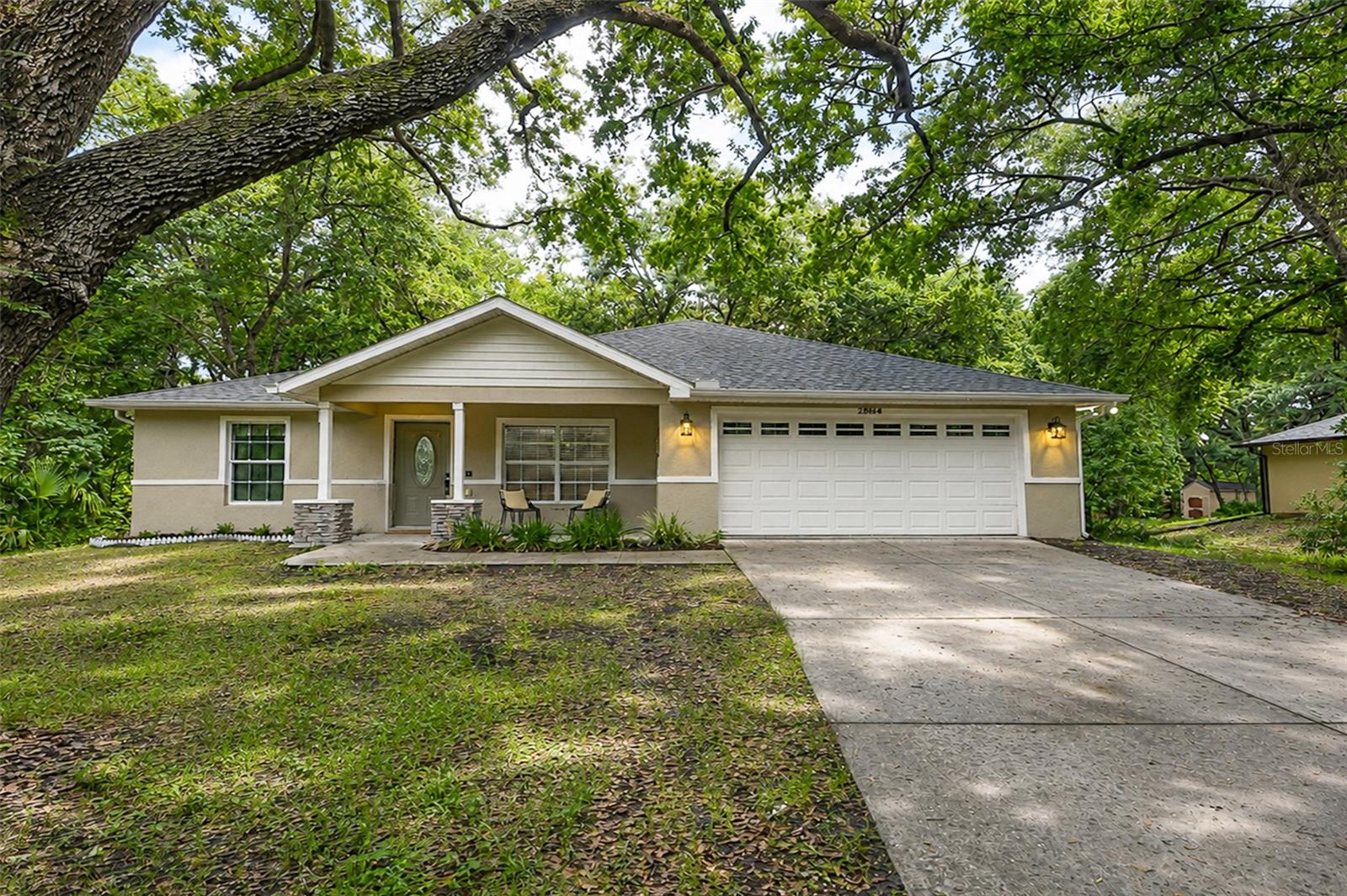 One or more photo(s) has been virtually staged. 3 Bedrooms | 2 Bathrooms | .52 Acres | Built 2006 | No HOA 
Tucked away beneath a breathtaking canopy of mature oaks, this charming DeLand retreat offers the feeling of a private woodland escape while remaining just minutes from everything you need. Situated on over half an acre, this 3-bedroom, 2-bath home welcomes you with, an open-concept design, and peaceful views from nearly every window.
Whether you're enjoying morning coffee on the front porch, entertaining around the spacious kitchen island, or unwinding in the quiet backyard surrounded by nature, this home was designed for comfortable Florida living. With a split-bedroom floor plan, generous living spaces, a two-car garage, and no HOA restrictions, you'll enjoy both flexibility and privacy in a setting that feels worlds away from the hustle and bustle.

Conveniently located approximately half a mile from the River and Marina,  near downtown DeLand, Stetson University, shopping, dining, and major commuter routes, total travel time from the interstate exit is typically 15 to 20 minutes, depending on traffic conditions.