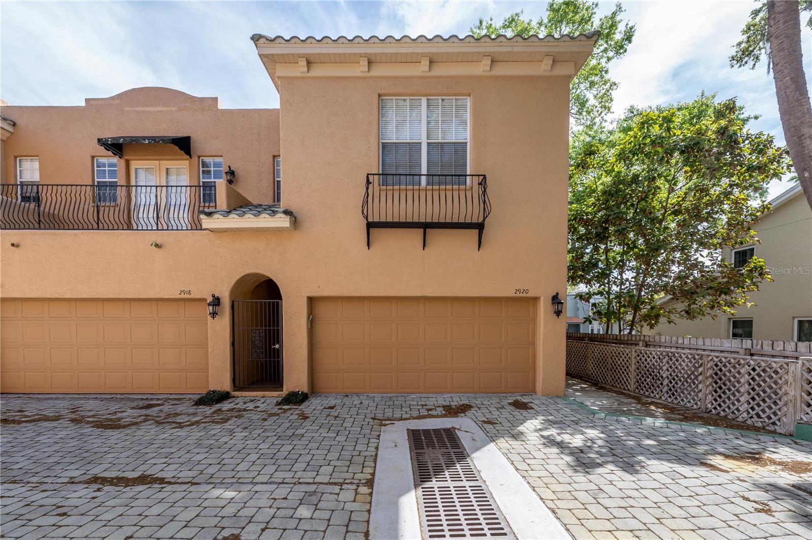 This gated townhome can come furnished if preferred, with high ceilings, 3 bedrooms and 2.5 baths. One of our favorite things about this one is the natural light it receives by being positioned as an end unit and having 2 substantial skylights on the second floor. The kitchen features an open island bar, a gas stove top, dining room fireplace, and all the essential kitchenware, as well as some of the extras. Off the kitchen there is a door leading to a wooden deck and peaceful green space. The bedrooms are located upstairs, the primary suite features a walk-in closet, and a Sleep Number bed. The two additional bedrooms share a bath and the laundry area is located upstairs for convenience. You will find ample storage through the home and if that's not enough space, there is a 2 car garage. This home offers an easy move, just bring your personal items and enjoy the best of South Tampa living.