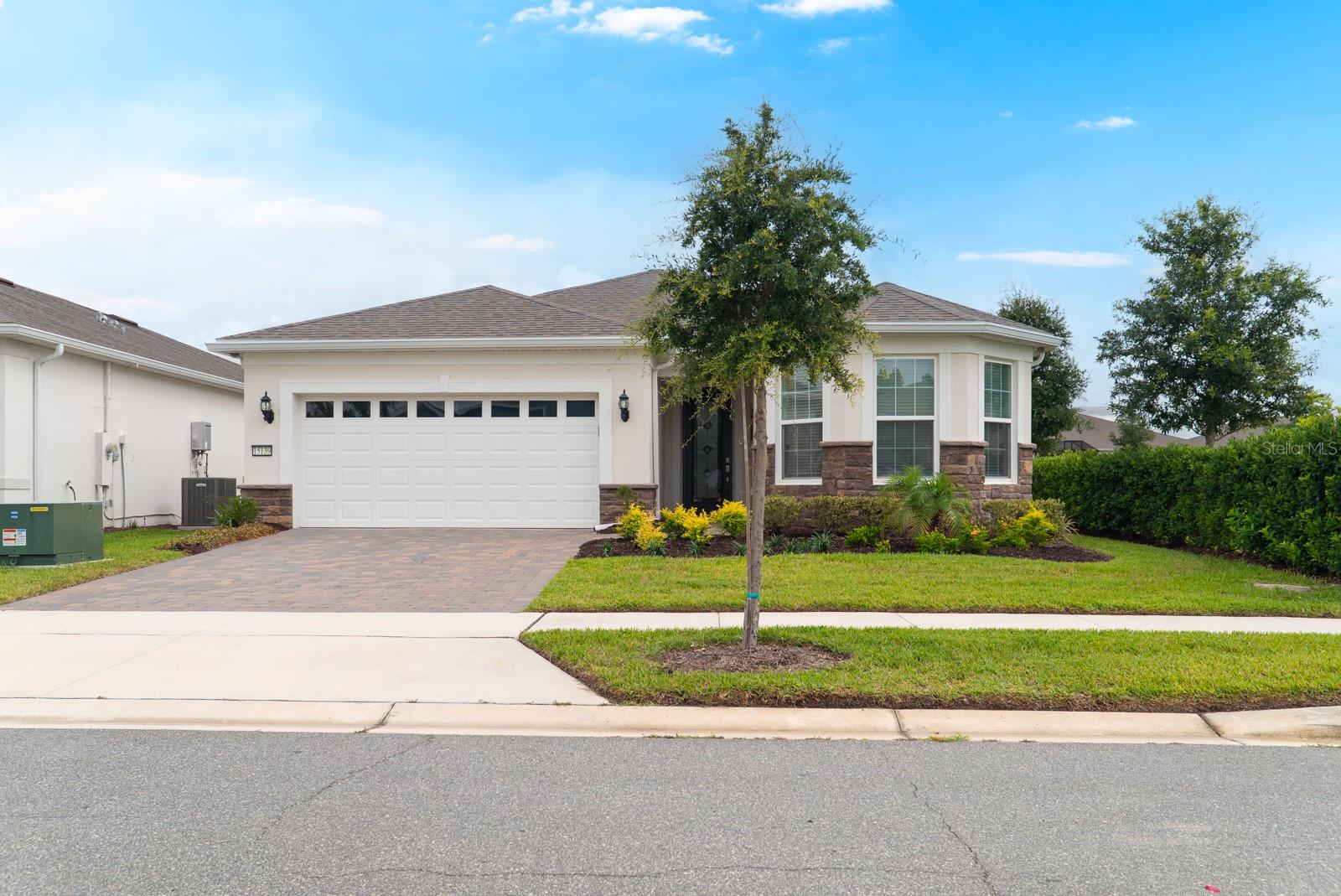 Welcome to this ELEGANTLY UPGRADED and nearly new 2-bedroom, 2-bath residence in the highly sought-after Del Webb Oasis of Winter Garden, a GUARD-GATED 55+ community where resort-style living meets everyday sophistication. Perfectly situated on one of ONLY TWO PREMIUM HOMESITES of its kind within the community, this exceptional property enjoys a truly rare distinction: an EXCLUSIVE SIDE EASEMENT that creates exceptional privacy, expanded green space, and a level of openness rarely found in community living, with no immediate neighbor on one side and convenient proximity to the clubhouse area.
From the moment you arrive, the home impresses with its REFINED CURB APPEAL, lush landscaping, and a spacious 2-car garage enhanced with CUSTOM STORAGE SOLUTIONS. Inside, a bright OPEN-CONCEPT LAYOUT welcomes you with abundant natural light and meticulous attention to detail throughout every space. The Kitchen is a TRUE SHOWPIECE, equipped with premium stainless steel appliances, a GAS COOKTOP, BUILT-IN OVEN, a CUSTOM BUILT-IN PANTRY WITH PULL-OUT DRAWERS, generous cabinetry, and stone countertops, all seamlessly flowing into the living and dining areas. The Living Room has been elevated with an INTEGRATED SURROUND SOUND SYSTEM, creating the perfect setting for daily enjoyment and entertaining. The Primary Suite is a private retreat featuring a CUSTOM-DESIGNED WALK-IN CLOSET SYSTEM and a well-appointed en-suite bath with dual vanities, generous storage, and a walk-in shower. An additional SECONDARY BEDROOM provides comfortable accommodations for family or guests, while the DEDICATED DEN, enhanced with UPGRADED HIGH BASEBOARDS and RECESSED LIGHTING, offers the flexibility of a home office, hobby room, or formal sitting area. CUSTOM CLOSET SYSTEMS throughout ensure every space is as functional as it is beautiful. Step outside to where this property truly STANDS APART. The expansive SCREENED-IN LANAI opens to an EXTENDED OUTDOOR DECK and a fully appointed BUILT-IN OUTDOOR KITCHEN (BBQ Area), all framed by CUSTOM OUTDOOR LIGHTING, creating an exceptional outdoor retreat designed for year-round Florida living.
Additional highlights include a WHOLE-HOME WATER FILTRATION AND SOFTENER SYSTEM, FRESH INTERIOR PAINT throughout, and additional RECESSED LIGHTING both inside and outside that elevates the home's ambiance day and night.
Residents of Del Webb Oasis enjoy RESORT-STYLE AMENITIES, including a 12,000 SF clubhouse with coffee bar, lounge, and wine lockers, a sparkling pool, state-of-the-art fitness center, tennis courts, and a vibrant social calendar, along with included cable and internet, fostering the active and connected lifestyle that Del Webb is famous for. IDEALLY LOCATED in Winter Garden, you are just minutes from the charm of HISTORIC DOWNTOWN WINTER GARDEN, known for boutique shops, dining, and a weekly farmers market. Enjoy outdoor recreation along the WEST ORANGE TRAIL, or take a short drive to WORLD-CLASS ATTRACTIONS including Walt Disney World Resort and Universal Studios. Convenient access to FL-429 and major roadways makes it easy to enjoy the very best of Central Florida.
This exceptional residence offers a RARE OPPORTUNITY to enjoy elevated, low-maintenance living on one of the community's most coveted homesites, where every upgrade has been thoughtfully chosen and every detail meticulously executed. Homes of this caliber and setting are a TRUE RARITY in Del Webb Oasis. Now is the time, don't miss your chance to call this home.