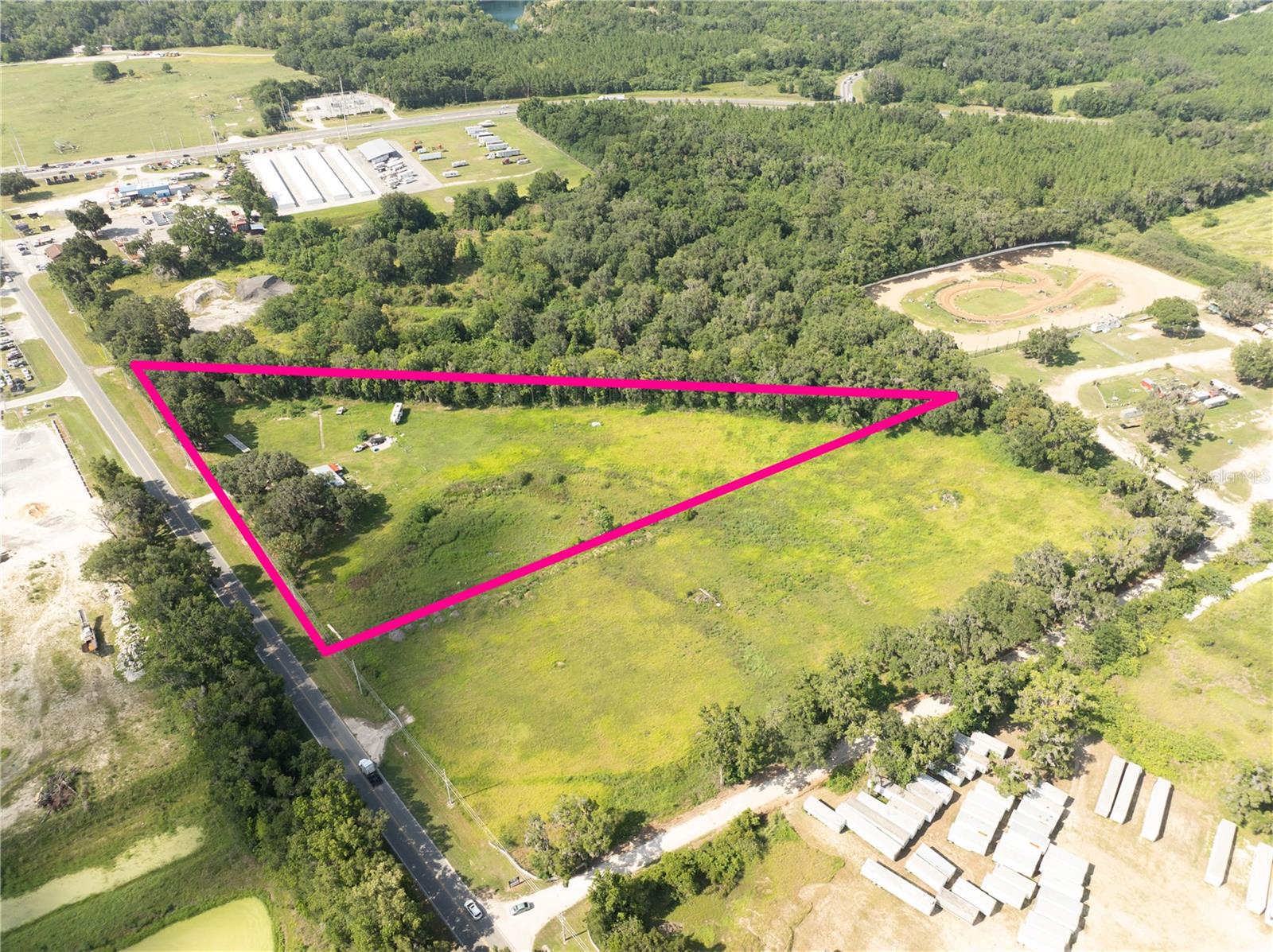 Prime M-2 Industrial Opportunity in North Ocala! Positioned in Ocala's thriving northern industrial corridor, this exceptional 4.42± acre M-2 zoned property offers outstanding potential for a wide range of industrial, commercial, and outdoor storage uses. The site includes a 1,264± square foot site-built residence that presents an excellent opportunity for conversion into office space, a showroom, customer reception area, or other business-related uses. Boasting approximately 624 feet of frontage along NW Gainesville Road, the property provides excellent visibility and accessibility with convenient access to Highway 326 and close proximity to Highway 301, Interstate 75, and other major transportation routes, making it ideal for distribution, service operations, contractors, manufacturing, and industrial users. The existing structure features durable CBS construction, a metal roof, and a newer air conditioning system, creating a solid foundation for redevelopment or adaptive reuse to fit your business needs. Of the total acreage, approximately 3.08 acres lie outside of the flood plain, with approximately 1.34 acres located within the flood plain, providing ample usable land for future improvements and development opportunities. Rarely do industrial parcels with this combination of zoning, visibility, road frontage, and existing improvements become available in this rapidly growing market.