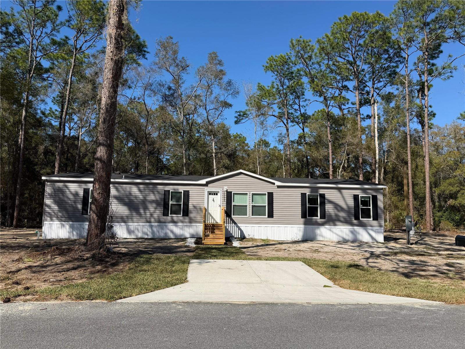 Brand-new 4-bedroom, 2-bath manufactured home on a .24-acre CORNER LOT in Crystal River. No HOA. You own the land. Completely new construction with new roof, new HVAC, new appliances, new septic system, and new well—ideal for low-maintenance ownership and strong rental potential. Open-concept layout with modern finishes, energy-efficient windows, spacious kitchen with pantry, and large laundry room with private entrance. All bedrooms include walk-in closets. Primary suite features a walk-in shower and garden tub. Property offers abundant outdoor space and a beautiful backyard with mature trees, providing privacy and long-term appeal for tenants or owner-occupants. Fully financeable and insurable. A solid investment opportunity with minimal future expenses and high demand for long-term rentals in the area.