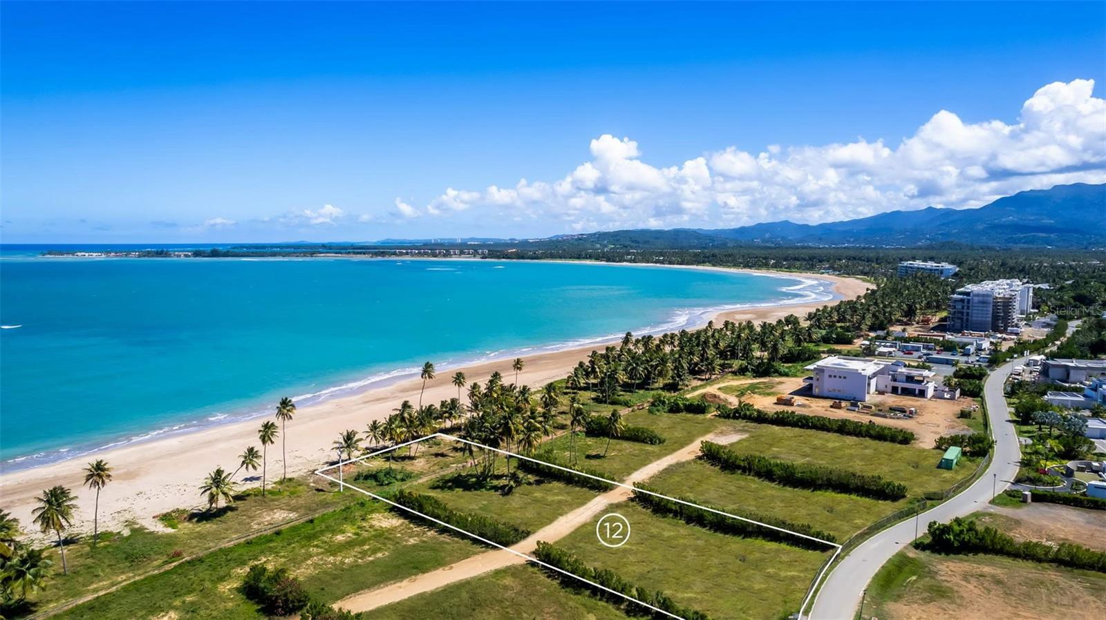 One or more photo(s) has been virtually staged. Lot #12 is the sole beachfront lot currently available for sale, offering the opportunity to design and build your custom home! This is a truly rare offering, with no comparable properties currently on the market.

Spanning 4,048 Sq. Mts., this property features 120 feet of beachfront with direct access and breathtaking views of the Atlantic Ocean.

Atlantic Drive enjoys a prime location west of The Four Seasons Resort.

The Four Seasons Resort, at Bahia Beach Resort is a private, gated community featuring world-class amenities, including:

A two-mile sandy beachfront.

An oceanfront golf course designed by Robert Trent Jones Jr.
The Beach Club.

Multiple dining options and the renowned The Four Seasons Resort Bar.
A state-of-the-art Wellness Center and Spa.

Two bird sanctuaries and an on-site team of marine biologists.

Residents and guests can enjoy a variety of activities, such as golfing, kayaking, paddleboarding, windsurfing, fishing, nature walks, 4.5 miles of hiking and biking trails, playing tennis, relaxing at the beach club or simply unwind on the beach.