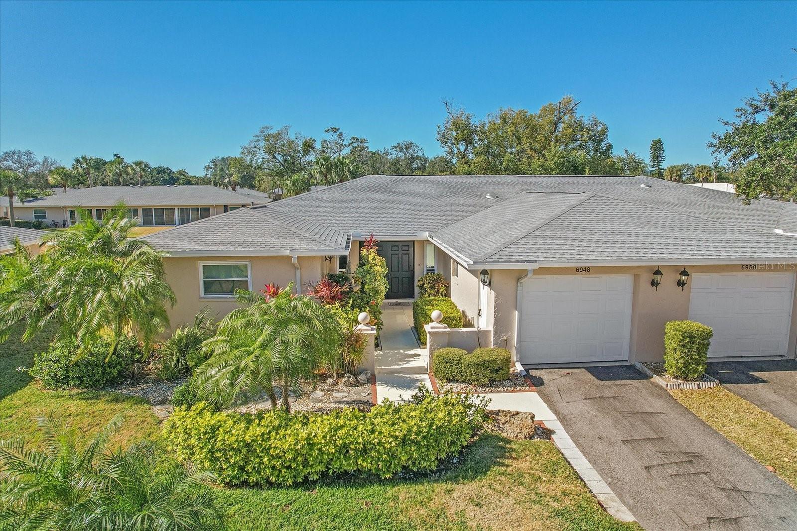 Welcome to effortless Florida living in this beautifully maintained villa located in the desirable Palm-Aire Country Club community of sunny Sarasota. This home offers 3 bedrooms, with the third bedroom perfect for a home office or den, along with 2 full bathrooms. Enter through the courtyard into the large living room, which nicely separates the bedrooms from the formal dining space and kitchen. The dining room is located between the living room and kitchen, making meals and time with friends and family easy to enjoy together. Relish in abundant natural light in the spacious Florida room, fully enclosed with sliding glass doors—ideal for relaxing, entertaining, or enjoying your morning coffee or evening tea year-round. Lush Florida landscaping behind the home allows for privacy, yet through an easy exit out the sliding glass doors, you'll find a large grassy area perfect for your pet or other activities in the fresh air. The bedrooms offer privacy with one in the front of the home and the others in the rear. The third bedroom is currently used as an office and could easily be separated from the primary bedroom for use as a guest room. An oversized 1 car garage has plenty of room for extra storage and your vehicle. The home features a newer roof, all hurricane impact windows, and has been meticulously cared for by the owner, providing peace of mind and pride of ownership. The community pool and shuffleboard courts are just steps away, offering quick access to recreation and socializing. An optional membership at Palm-Aire Country Club will get you unlimited golf, pickleball, another pool, wonderful Sunday brunch and other meals, tons of social events and additional amenities to keep you busy. Perfectly situated, this villa is minutes from shopping and dining at UTC, a short drive to downtown Sarasota, and not far to the area’s renowned white sand beaches. With a low-maintenance lifestyle, this home delivers comfort, convenience, and classic Sarasota charm -  schedule your showing today!