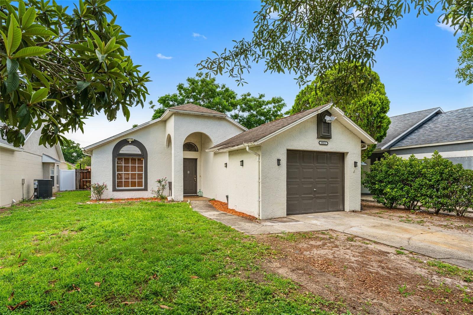 BRAND-NEW ROOF TO BE INSTALLED AT CLOSING—BUYER CHOOSES THE SHINGLE COLOR! Discover the perfect blend of Florida charm and Spanish Revival character in this beautiful 2-bedroom, 2-bath home! Major systems have been thoughtfully updated, including a 2022 HVAC and a 2020 WHOLE-HOUSE RE-PLUMB. Soaring vaulted ceilings, updated light fixtures and ceiling fans, and a functional floor plan create a bright and inviting living space, while the kitchen features real wood cabinetry, a stainless steel farm sink, and a custom tiled backsplash. The spacious primary retreat offers high vaulted ceilings, a generous walk-in closet, and a private en-suite bath, while a second bedroom and full bath add convenience. Step outside to your private backyard oasis, complete with a tall privacy fence, a NEW brick paver patio (2025), and a screened porch with a ceiling fan—perfect for entertaining or relaxing year-round. Perfectly located only minutes from famous Waterford Lakes Town Center, this home gives you easy access to UCF, the 408, amenity-filled parks, and top shopping and dining options. Don't miss this gem!