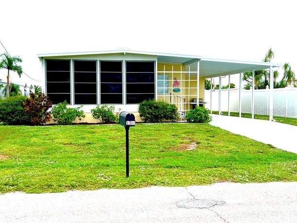 55+ community- VERY WELL MAINTAINED.. suffered VERY MINIMAL IAN DAMAGE,  OFFERS NEW CARPET, FRESH PAINT, FURNISHED, AND YOU OWN THE LOT! ON A FRESHWATER CANAL where you can fish from your yard. Just minutes to the beaches, shops, stores, and restaurants. located in a "VOLUNTARY MOBILE HOME ASSOCIATION" community. www.holiday-estates.org. ASSOCIATION ACTIVITIES INCLUDE BINGO, COUNTRY BREAKFASTS, CRAFTS, CRAFT SALES, DANCES, CARD PARTIES AND DINNERS. BOAT RAMP ACCESS INCLUDED WITH MEMBERSHIP. SECURITY PATROLLED. ROADS OWNED AND MAINTAINED BY THE COUNTY.