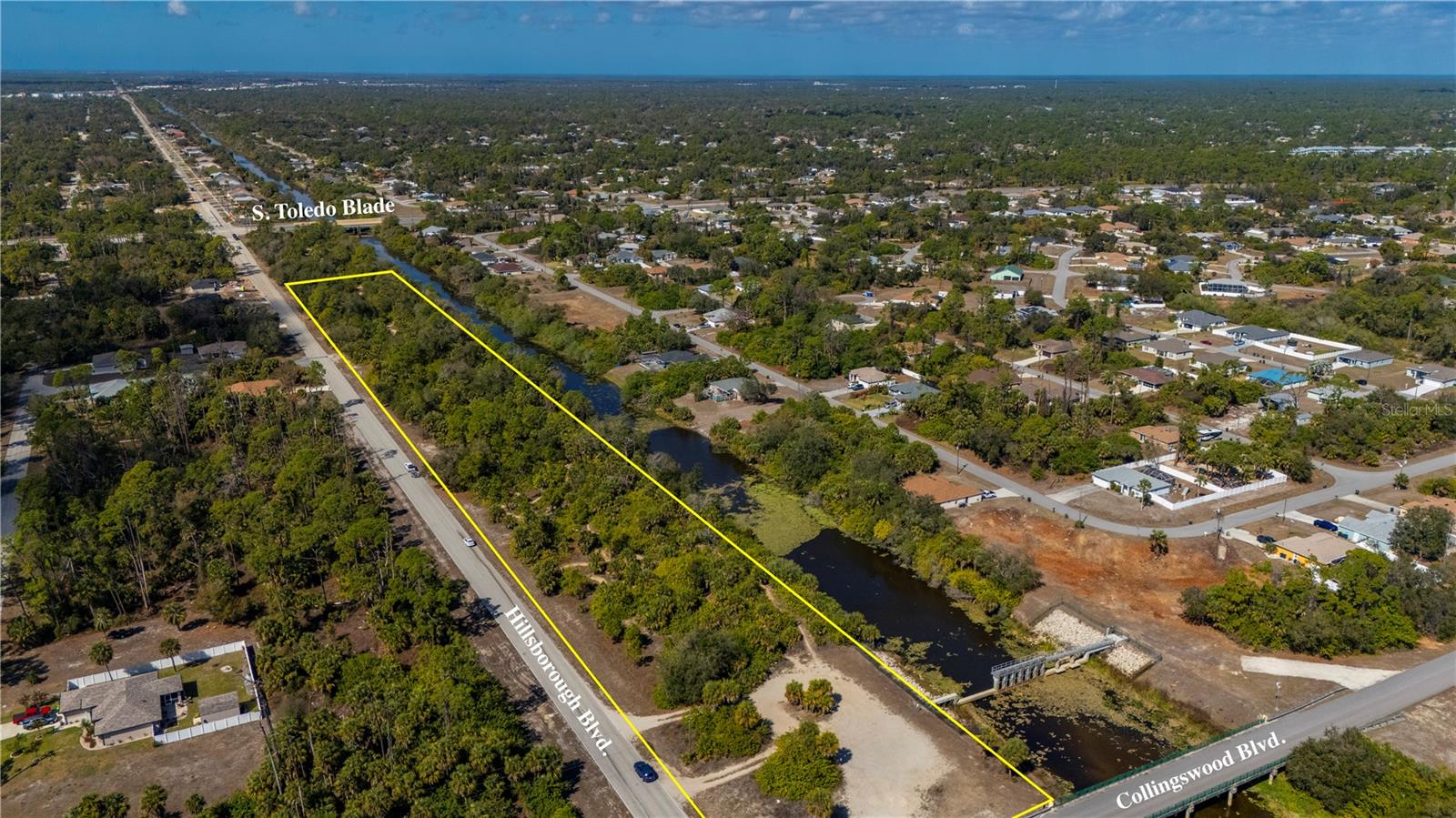 Prime 5.76± Acre Mixed-Use Development Opportunity. This NON-FLOOD zone parcel is located on Hillsborough Blvd in the City of North Port, bordering Port Charlotte. Zoned Corridor Transitional (CT), which supports mixed-use development potential including residential integrated with commercial or office uses (subject to City of North Port regulations). The property features over 1,700 feet of road frontage and extends approximately 145 feet in depth, offering a flexible layout for a variety of development concepts. The rear of the property backs to a canal, providing a natural buffer and sense of peace. City water is available. Conveniently located with access to major roadways, established neighborhoods, and growing commercial corridors. North Port continues to experience ongoing growth and infrastructure expansion, making this a strong opportunity for investors and developers seeking corridor-zoned acreage.