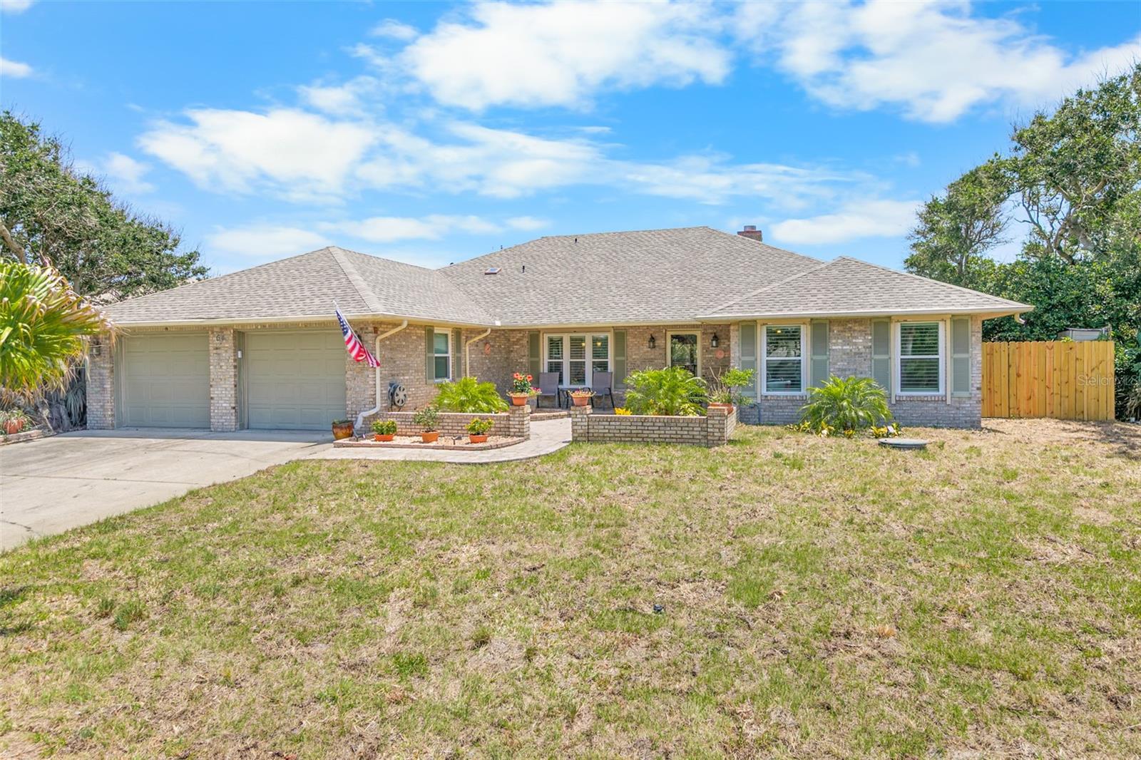 This distinctive 3BR/2BA custom beachside home designed and built by renowned local builder, Jay Dickinson, incorporates exceptional workmanship and enduring quality. Located one block to the beach access of the pristine ''no drive'' sugar sand beach in sought after Ponce Inlet!! Interior features include 2,285 sq. ft. of luxurious living area plus an oversized two car garage with attic. The desirable split bedroom floor plan features a light & bright open concept with vaulted ceilings, a wood burning fireplace and many upgrades. The main bedroom is a large two room suite boasting a large walk-in closet, updated master bath & adjoining room perfect for an office, nursery, gym, etc. Both guest bedrooms are also spacious and ideally located near the guest bathroom. The brick exterior offers exceptional durability & low maintenance, and a brick paver front patio provide an inviting entryway and beautiful curb appeal. The large lot is high & dry and located in flood zone "X", so flood insurance is not required. Upgrades showcase new exquisite Porcelain tile flooring flooring throughout, all new windows & sliding doors, freshly painted interior, new baseboards, hurricane shutters throughout living areas, Plantation shutters on all windows & sliding doors, large inside laundry room with ample cabinets & utility sink, new roof in 2022, new HVAC system in 2019, updated kitchen with stainless steel appliances, granite countertops, full backsplash, wood cabinetry, ample counter and storage space. Relax in the comfortable newly screened rear patio overlooking the privacy fenced back yard with beautiful shade trees. Brand new sod in the front and rear yard are easily maintained with the programmable sprinkler system. City water service & a newer septic system provide reliability and peace-of-mind. Walk or bike to the historic Ponce Inlet Lighthouse and jetty park, Marine Science Center, waterfront restaurants with entertainment, marinas, parks, dog park/beach and much more!! Ponce Inlet provides the ultimate environment for relaxed beachside living combined with a community atmosphere.
