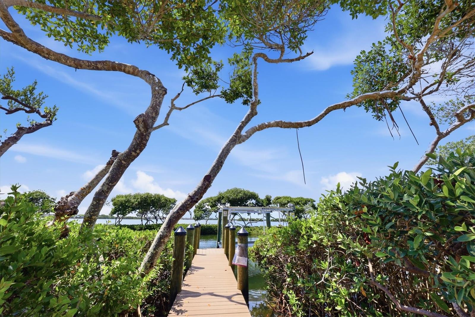 Nestled behind the gates of the highly celebrated Bay Isles community, this exceptional five-bedroom waterfront residence at 3606 Fair Oaks Lane offers the perfect blend of luxury, comfort, and peace of mind with an impressive list of recent upgrades and improvements. Designed for effortless coastal living, this beautifully updated home showcases refined interiors, expansive outdoor living spaces, and direct boating access, all within one of Longboat Key’s most sought-after neighborhoods. From the moment you arrive, the home’s meticulous maintenance and thoughtful renovations are immediately apparent. A roof just two years old, hurricane shutters on all windows and doors, and multiple updated mechanical systems provide exceptional value and confidence for years to come. Inside, the residence has been extensively renovated in 2026 with stunning new engineered wood flooring flowing throughout the home, creating a warm and welcoming coastal aesthetic. The spacious floor plan offers five generously sized bedrooms, ideal for accommodating family and guests while maintaining privacy and flexibility for today’s lifestyle needs. The heart of the home is the beautifully refreshed kitchen, complete with brand-new KitchenAid appliances installed in 2026, blending modern functionality with timeless design. Adjacent living and dining areas are filled with natural light and seamlessly connect to the outdoor entertaining spaces, creating an inviting atmosphere perfect for both everyday living and hosting gatherings. Every bathroom in the home was completely renovated in 2026 with stylish finishes and contemporary details that elevate the home’s overall elegance. Extensive system upgrades include three HVAC systems replaced in 2022, 2023, and 2026, along with a new hot water heater installed in 2026, ensuring maximum efficiency and comfort throughout the property. Outdoor living is equally impressive and designed to embrace the Florida waterfront lifestyle. The pool area underwent a significant transformation in 2025 with new pool decking, a resurfaced pool finish, updated waterline tile, and a new gas pool heater, creating a true private resort setting. In 2026, the addition of a fully equipped outdoor kitchen elevated the entertaining experience even further, offering the perfect backdrop for waterfront dining and sunset gatherings. Boating enthusiasts will appreciate the new 10,000-pound boat lift installed in 2025 along with a beautifully updated dock and deck, providing quick and convenient access to Sarasota Bay and the Gulf waters beyond. Combining luxury updates, exceptional outdoor amenities, and a premier location within the coveted Bay Isles community, with private beach club access, this extraordinary Longboat Key residence presents a rare opportunity to enjoy refined waterfront living with every major improvement already completed.
