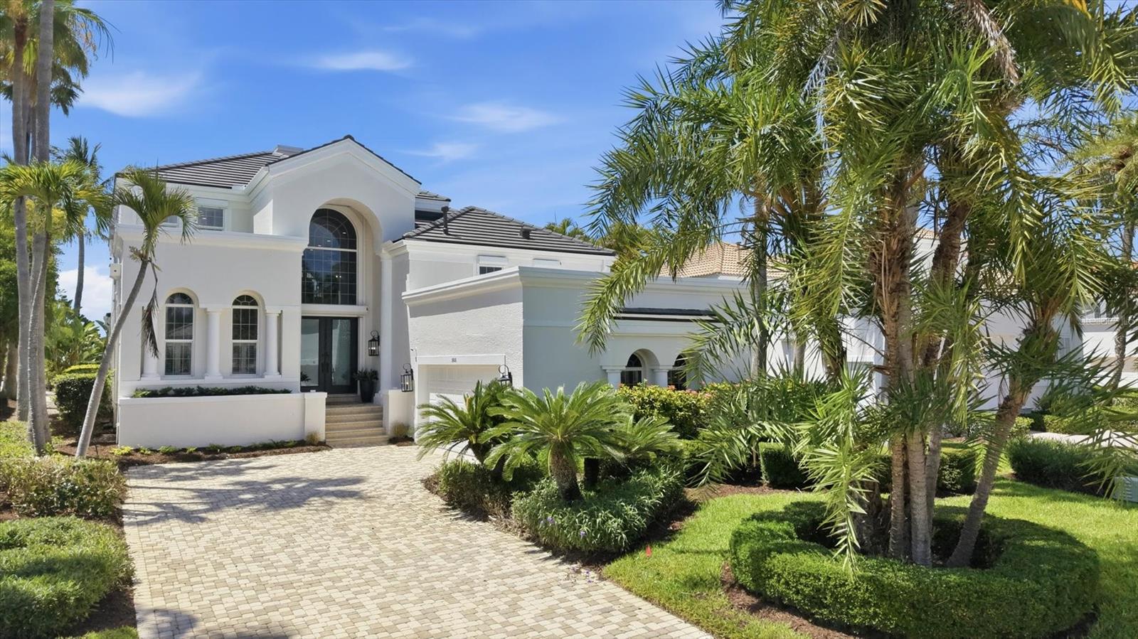 Nestled behind the gates of the highly celebrated Bay Isles community, this exceptional five-bedroom waterfront residence at 3606 Fair Oaks Lane offers the perfect blend of luxury, comfort, and peace of mind with an impressive list of recent upgrades and improvements. Designed for effortless coastal living, this beautifully updated home showcases refined interiors, expansive outdoor living spaces, and direct boating access, all within one of Longboat Key’s most sought-after neighborhoods. From the moment you arrive, the home’s meticulous maintenance and thoughtful renovations are immediately apparent. A roof just two years old, hurricane shutters on all windows and doors, and multiple updated mechanical systems provide exceptional value and confidence for years to come. Inside, the residence has been extensively renovated in 2026 with stunning new engineered wood flooring flowing throughout the home, creating a warm and welcoming coastal aesthetic. The spacious floor plan offers five generously sized bedrooms, ideal for accommodating family and guests while maintaining privacy and flexibility for today’s lifestyle needs. The heart of the home is the beautifully refreshed kitchen, complete with brand-new KitchenAid appliances installed in 2026, blending modern functionality with timeless design. Adjacent living and dining areas are filled with natural light and seamlessly connect to the outdoor entertaining spaces, creating an inviting atmosphere perfect for both everyday living and hosting gatherings. Every bathroom in the home was completely renovated in 2026 with stylish finishes and contemporary details that elevate the home’s overall elegance. Extensive system upgrades include three HVAC systems replaced in 2022, 2023, and 2026, along with a new hot water heater installed in 2026, ensuring maximum efficiency and comfort throughout the property. Outdoor living is equally impressive and designed to embrace the Florida waterfront lifestyle. The pool area underwent a significant transformation in 2025 with new pool decking, a resurfaced pool finish, updated waterline tile, and a new gas pool heater, creating a true private resort setting. In 2026, the addition of a fully equipped outdoor kitchen elevated the entertaining experience even further, offering the perfect backdrop for waterfront dining and sunset gatherings. Boating enthusiasts will appreciate the new 10,000-pound boat lift installed in 2025 along with a beautifully updated dock and deck, providing quick and convenient access to Sarasota Bay and the Gulf waters beyond. Combining luxury updates, exceptional outdoor amenities, and a premier location within the coveted Bay Isles community, with private beach club access, this extraordinary Longboat Key residence presents a rare opportunity to enjoy refined waterfront living with every major improvement already completed.