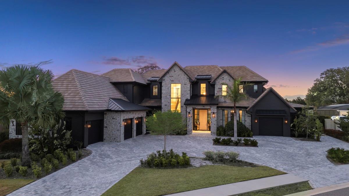 Introducing a one of a kind, breathtaking custom estate situated on the 15th fairway of the world-renowned Arnold Palmer’s Bay Hill Club & Lodge. Newly constructed with uncompromising craftsmanship and thoughtful design, this 5-bedroom, 8-bath masterpiece is a rare offering that blends luxury, comfort, and true resort style living. From the moment you step inside, the grand great room sets the tone with soaring ceilings and seamless integration into the chef inspired kitchen, featuring top-of-the-line Wolf and Sub-Zero appliances, custom cabinetry, stunning quartzite counters, and an expansive center island. A hidden prep kitchen with a walk-in pantry, additional oven, stove, dishwasher, and sink elevates the home’s functionality for both daily living and large-scale entertaining.

Every inch of this residence was designed for ease and indulgence, including two laundry rooms with one conveniently located upstairs near the three secondary bedrooms and another within the primary suite’s private mudroom. A second mudroom off the oversized 4-car garage (plus dedicated golf cart garage) adds even more convenience. The home also features an upstairs playroom/fitness room, a full movie theater with projector and tiered seating, and an elegant indoor bar area perfect for unwinding or hosting. The primary suite is a true sanctuary, boasting a luxurious bathroom with a private sauna, an enormous walk-in shower with seating, a dedicated makeup vanity, floating mirrors and a stunning walk-in closet room. Designer Kohler fixtures grace every bathroom throughout the home.

Indoor/outdoor living takes center stage with an expansive covered lanai, a fully equipped summer kitchen, multiple outdoor TV areas, and a spectacular resort-style pool featuring a spa and sun shelf, all overlooking unobstructed golf course views. This home delivers unparalleled sophistication in one of Orlando’s most iconic communities. Residents enjoy the exclusive Bay Hill lifestyle, including country club dining, tennis, a premier fitness center, and, of course, the legendary Arnold Palmer golf course. With a location just minutes from Restaurant Row, world-class shopping, and all major theme parks, this extraordinary custom home is truly without equal. More professional pictures coming soon.