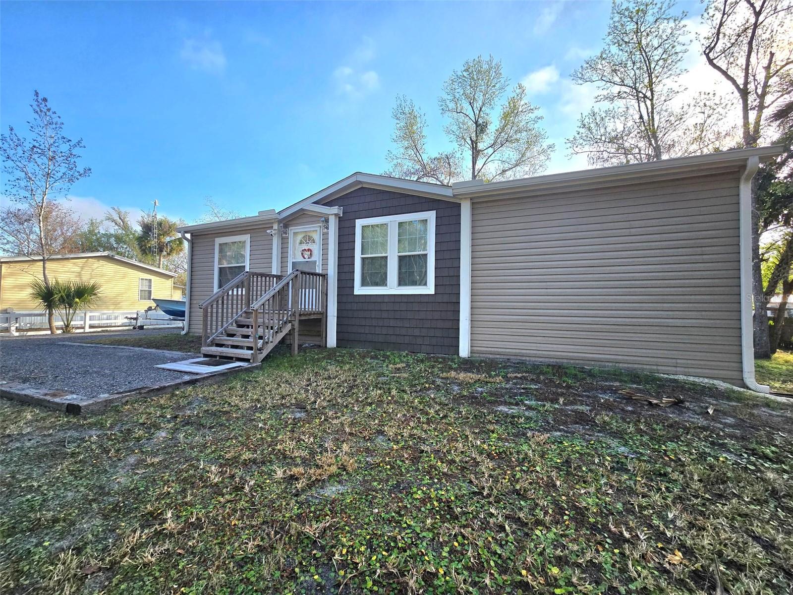Price Reduced on this Beautiful fully furnished 2023 home!!!! Located on a wide, deep-water canal with direct access to the St. Johns River. This home has been custom designed with Two Master suites, making it a great retreat for two couples, and open living area that connects to a fantastic outdoor deck and screened porch.  Absolutely Turnkey property!! This property has so many great features including a large driveway with asphalt millings, great storage building onsite for all your tools and toys. 19 ft Godfrey deck boat with full electronics and power pole with a 115 Yamaha 4 stroke and trailer included.  Along with a 50-amp power, Full hook-up pad for a RV including sewer. The kitchen appliances, washer, dryer, furniture, grill, and lawn mower will stay with the property!!  Whether you're boating, fishing, or simply enjoying the Florida lifestyle, this home offers comfort, convenience, and access to some of the area's best waterways.