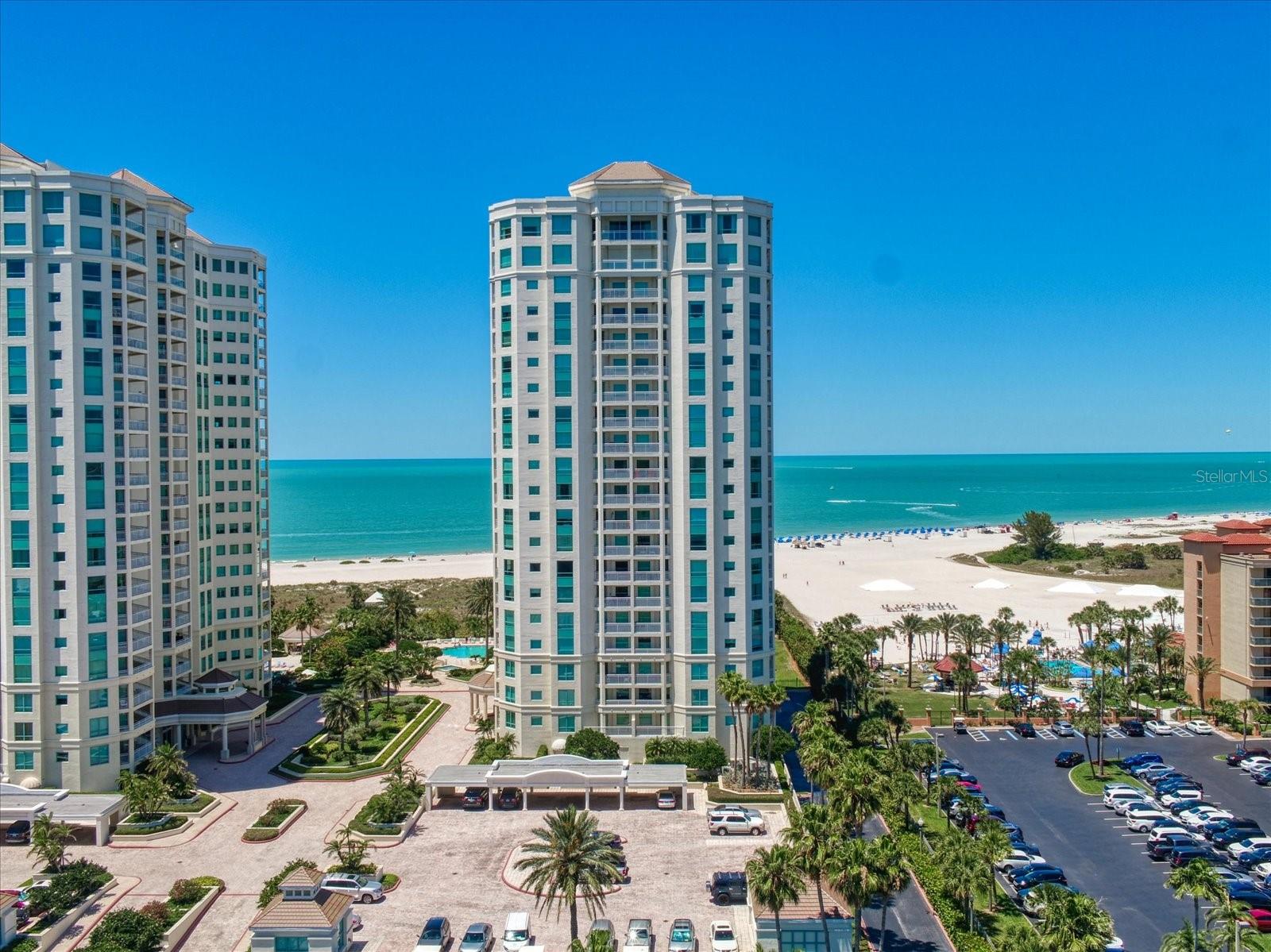 One or more photo(s) has been virtually staged. STRUCTUALLY ENHANCED WITH BRAND NEW HURRICANE RATED SLIDERS AND WINDOWS.  SUBLIME PLEASE MEET UNOBSTRUCTED. UNOBSTRUCTED WATER VIEWS OVER THE GULF OF MEXICO, CLEARWATER PASS, SAND KEY’S PARK AND BRIDGE, THE HARBOR, OUR CITY’S LIGHTS AND A FULL BLOWN PANORAMA OF ENGAGING DAY AND NIGHT TIME VISTAS, THAT IS. SUBLIME TELL US ABOUT ABOUT THE LEVEL 5 SKIM COATED CONSTRUCTION PERFECTION THAT LIES WITHIN…CUSTOM KITCHEN CABINETRY, STUNNING QUARTZITE COUNTERS, WORLD WORTHY APPLIANCES, ETHEREAL PAINT TREATMENTS, REMARKABLY SCALED TILE FLOORING THROUGHOUT, STRIKING TIMELESS BATHS APPOINTED IN BESPOKE CABINETRY, & ENCASED IN GORGEOUS STONE & TILE FOR AN INTEGRATED STREAMLINED LOOK AND FEEL. LEGENDARY FIXTURES, SOLID CORE DOORS, WITH MAGNIFICENT MILL WORK AND HARDWARE RESONATE THROUGHOUT THIS FULL 3 BEDROOM BELLUCIA WITHIN THE ICON THAT IS THE WATERMARK GRANDE ON NORTH SAND KEY BEACH. 14 ACRES OF RESORT INFUSED AMENITIES INCLUSIVE OF: MULTIPLE POOLS, COURTS, SOCIAL EMPORIUMS, STATE OF THE ART FITNESS CENTERS AWAIT YOUR EXTRAORDINARY WEST GULF COAST OF FLORIDA LIFESTYLE.
