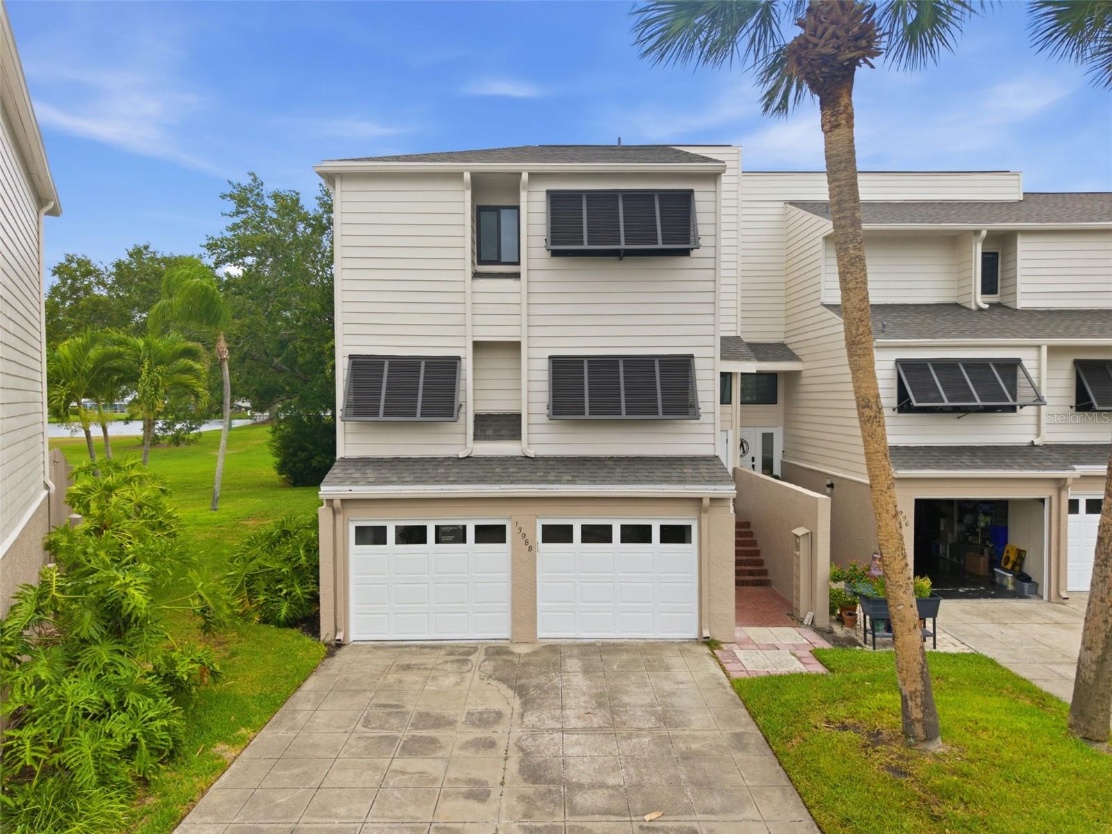 Welcome to Feather Sound, one of mid-Pinellas County's most convenient and desirable golf course communities. This spacious 3-bedroom, a 2.5-bath end-unit townhome offers over 2,000 square feet of living space, a 2-car garage, and peaceful pond and golf course views from a screened patio designed for relaxing Florida living.

Inside, the split-level layout features soaring ceilings, large windows, sliding glass doors, and an open, comfortable feel with abundant natural light. The home offers a spacious great room, dining area with built-ins, a kitchen with granite counters and a breakfast bar, and a private upper-level bedroom layout. The primary suite includes a walk-in closet and en-suite bath, while the additional bedrooms provide flexible space for guests, work-from-home needs, or everyday living.

Recent improvements include roof replacement, exterior paint, HVAC, impact windows, ceiling and lighting on first and second levels, laminate floors, updated lanai, hot water heater, bathroom updates, closet shelving and more.  The floor plan also offers the potential to convert the half bath to a full bath, creating added flexibility and value.

Perfectly positioned between Tampa, St. Petersburg, the beaches, shopping, dining, entertainment, and nearby airports, this location offers exceptional access while still feeling tucked away in a serene golf course setting. Whether you are looking for a primary residence, seasonal retreat, or low-maintenance Florida lifestyle, this Feather Sound townhome is a must-see