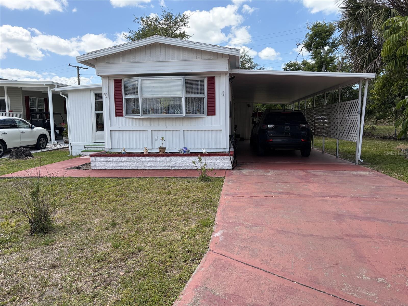This property features two bedrooms and one bathroom, encompassing 672 square feet, with an additional 136-square-foot air-conditioned bonus room. The home presents an excellent opportunity for renovation to suit personal preferences or as a potential income-generating investment. While the interior is dated, it offers considerable creative possibilities. Key upgrades include a TPO roof and several updated windows. There is also an extra-long carport for added convenience. 
Tri-par Estates is a 55+ community that provides a wealth of amenities: enjoy a heated and cooled large pool for year-round swimming, a brand-new spa, tiki hut, pickleball courts, fitness center, shuffleboard, miniature golf, horseshoes, and various recreation hall rooms equipped with ping-pong, billiards, card tables, a kitchenette, sewing areas, and more. The expansive clubhouse regularly hosts dinners, dances, and other events.
Situated only minutes from downtown Sarasota, you’ll have easy access to marinas, shopping, restaurants, museums, the world-renowned Siesta Key and Lido Key beaches, and Sarasota airport.
In this special park and recreation district, residents own their land directly, with no separate HOA fees—an annual fee of $1,648 is included in your property taxes. Internet and TV included in the annual fee This is also a golf cart-friendly community with optional RV or boat storage when available. Don’t miss the opportunity to join this lively, well-established neighborhood in paradise.
